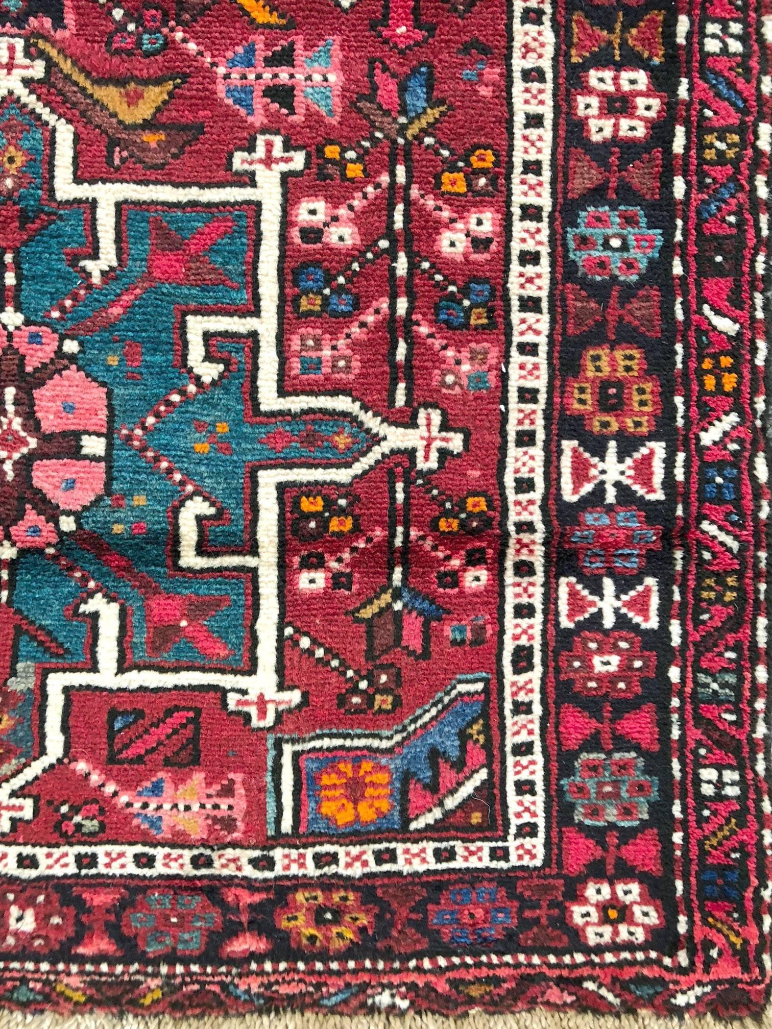 This piece has wool pile and cotton foundation. The base color is rust with black and multi-color border. This piece is in a great condition. The design is tribal and it has repeated medallions. Karajeh rugs get better when they age.