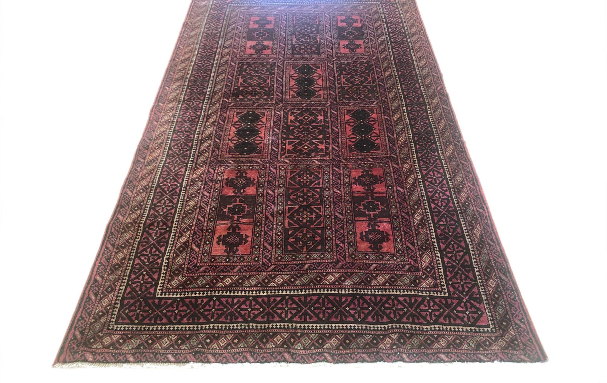 This authentic Persian Baluchi rug has wool pile and foundation which are hand knotted by the nomads of Baluchi. The age of this rug is almost 50 years old. The base color is salmon and the border colors are brown and salmon. The size of this rug is