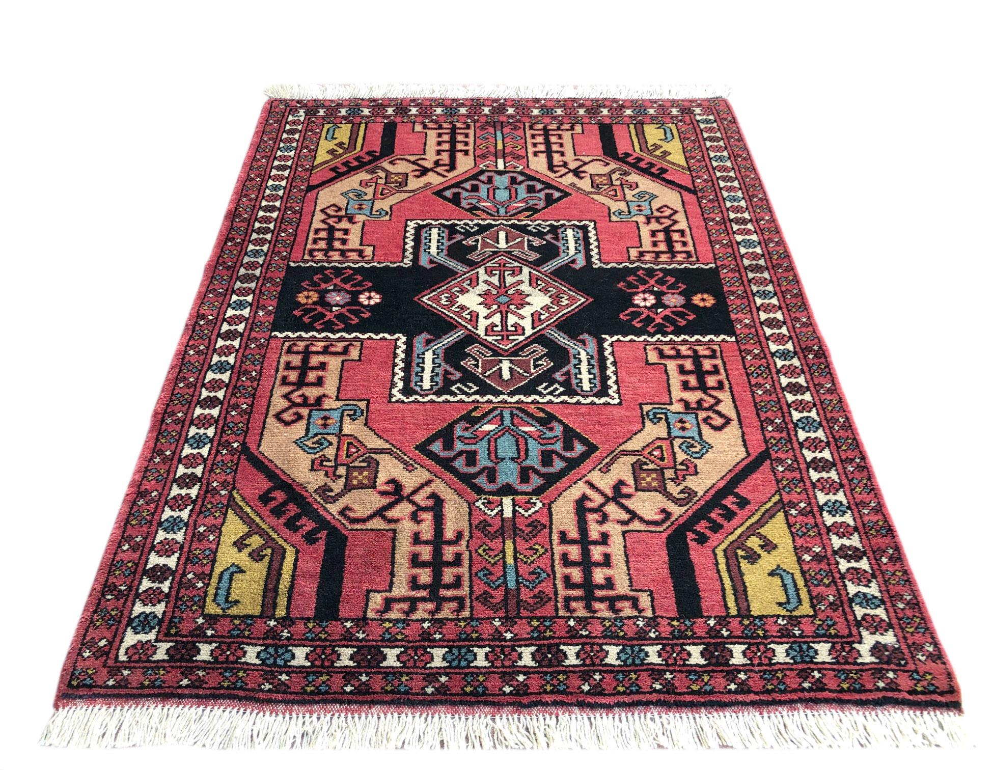 This authentic Persian Baluchi rug has wool pile and foundation which are hand knotted by the nomads of Baluchi. The age of this rug is almost 50 years old. The base color is salmon and the border color is salmon and cream. The size of this rug is 4