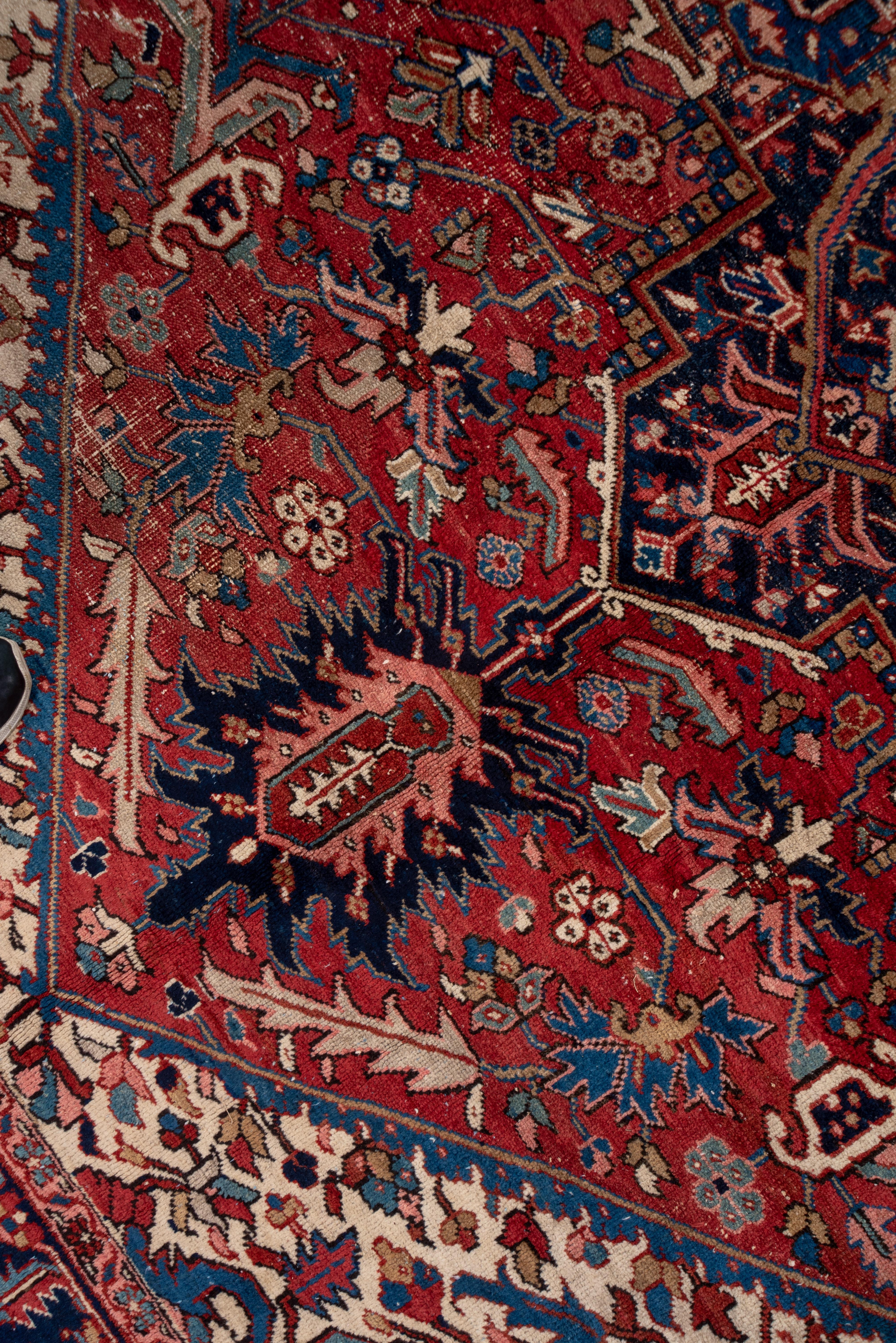 This NW Persian village carpet shows a good natural dye palette including the madder red field, the navy and garnet layered central octogramme medallion, the ivory corners and details in teal, medium blue and pale green. The iconic turtle palmette