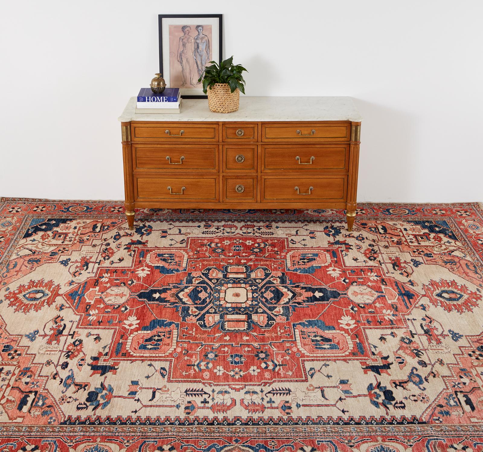 Exceptional 21st century Persian Heriz style Azeri carpet. Stylized floral geometric patterns over a light beige field. Lovely vivid indigo blue and pink accents decorate the field. Made of hand knotted wool from an estate in San Francisco, CA.
