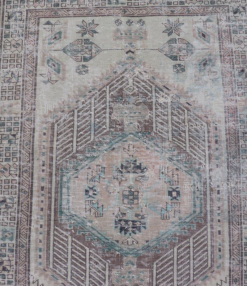 Vintage Persian Heriz distressed rug with muted colors and Medallion Design. Keivan Woven Arts / rug CRV-10056889, country of origin / type: Iran / Tabriz, circa 1950

Measures: 3'4 x 10'4
 
This vintage Persian Tabriz carpet features a refined