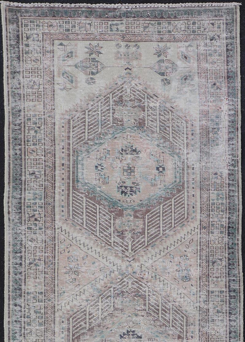 Hand-Knotted Vintage Persian Heriz Distressed Rug with Muted Colors & Medallion Design For Sale