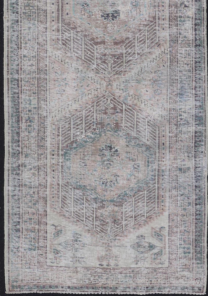 20th Century Vintage Persian Heriz Distressed Rug with Muted Colors & Medallion Design For Sale