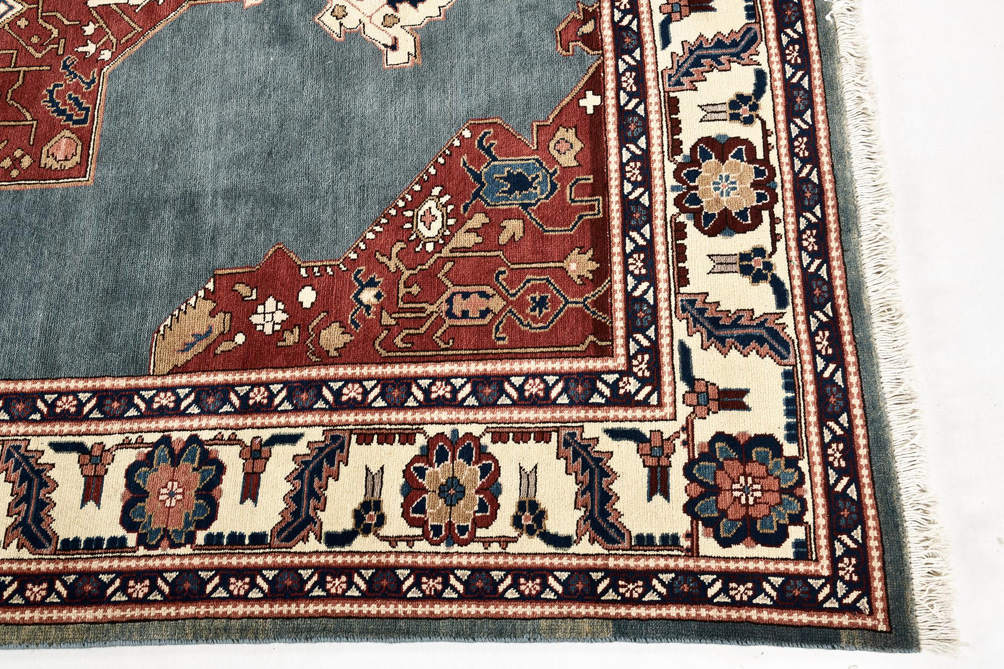 A majestic vintage Persian Heriz rug that is a masterpiece of renowned charm. Intricate embellishments in bold hues of terracotta, ivory and gold are harmoniously blending in a turquoise abrashed field that is exquisitely preserved in time. Every