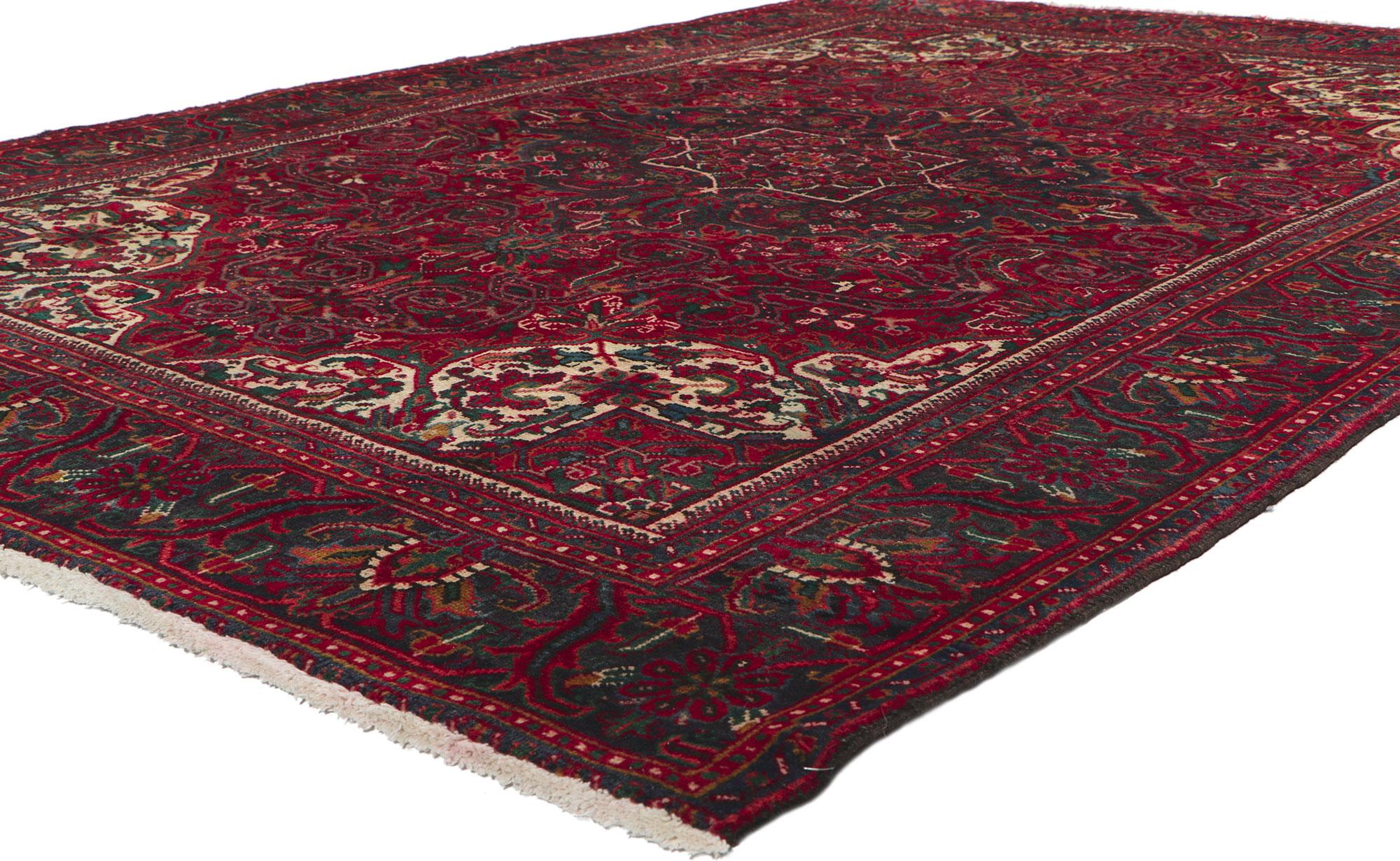 61032 Vintage Persian Heriz Rug, 06'09 x 09'07.
In an ambiance of warmth and timeless allure, behold this hand-knotted wool vintage Persian Heriz rug—a symphony of woven beauty that transcends the ordinary. The composition unfolds with a concentric