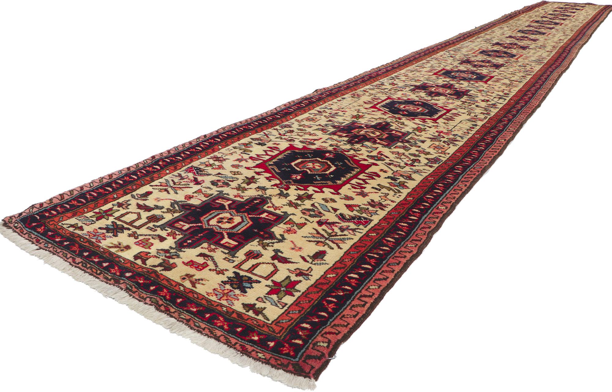 61220 Vintage Persian Heriz Runner 02'08 x 21'07. Full of tiny details and tribal style, this hand-knotted wool vintage Persian Heriz runner is a captivating vision of woven beauty. The abrashed beige field features an allover geometric pattern. It