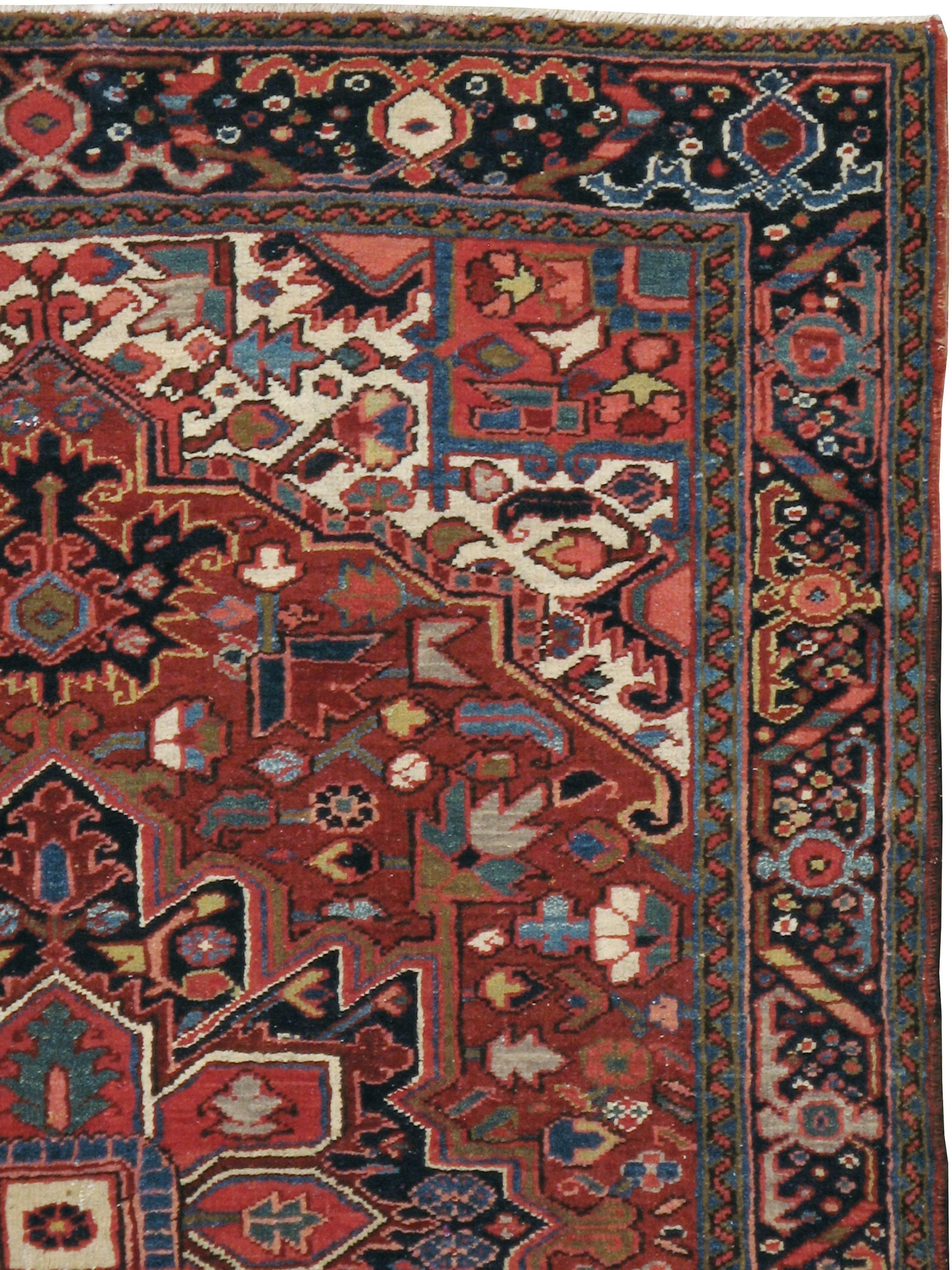 A vintage Persian Heriz rug from the mid-20th century.