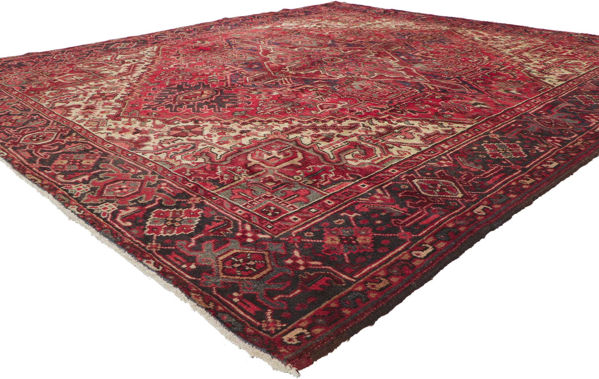 ?61124 vintage Persian Heriz rug, 07'07 x 08'08. Warm and inviting with a classic style, this hand-knotted wool vintage Persian Heriz rug charms with ease. The abrashed red field features a concentric octogram medallion surrounded by an allover