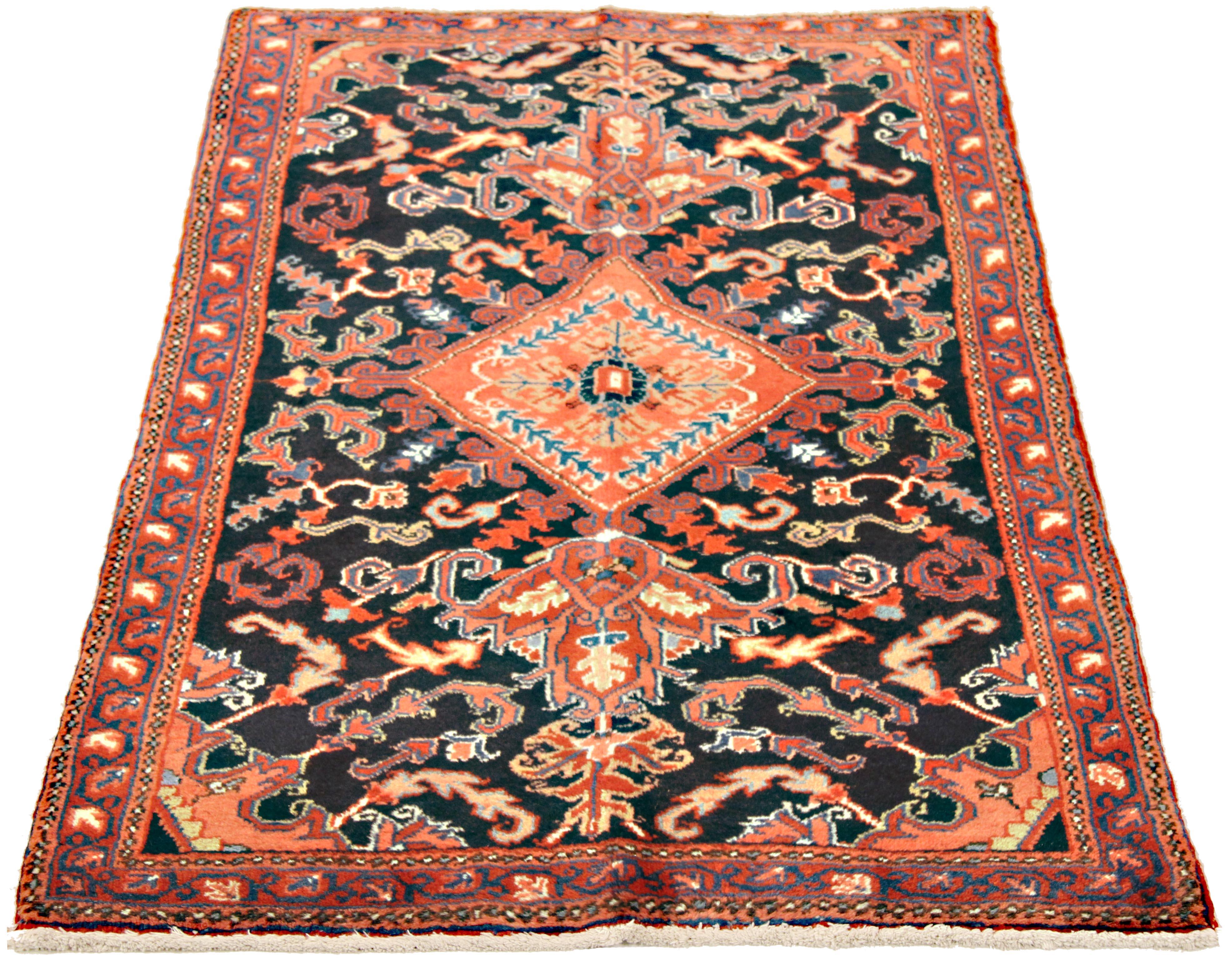 Vintage Persian rug handwoven from the finest sheep’s wool and colored with all-natural vegetable dyes that are safe for humans and pets. It’s a traditional Heriz design featuring a lovely black field covered with blue, red and pink floral and
