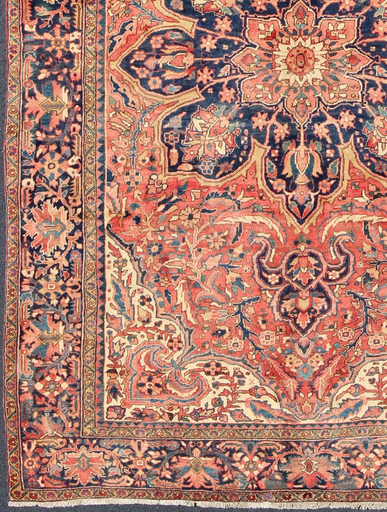 Midcentury Persian Heriz rug with floral medallion design in red and blue, rug h-507-06, country of origin / type: Iran / Heriz, circa 1950

This magnificent vintage Persian Heriz carpet from the mid-20th century (circa 1950) bears an exquisite