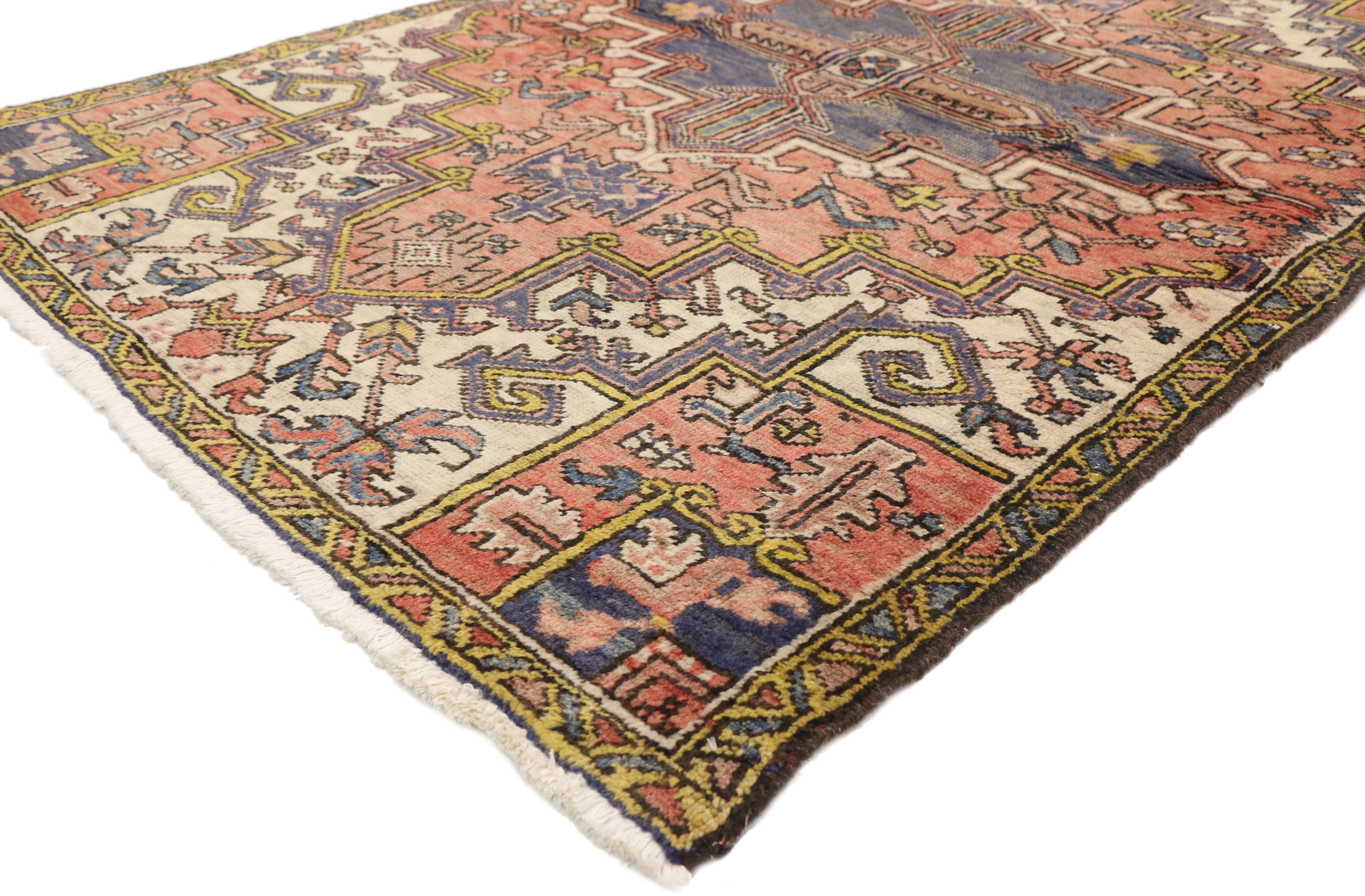 75110 vintage Persian Heriz rug with Mid-Century Modern Bohemian style. This hand knotted wool vintage Persian Heriz accent rug features a central medallion surrounded by an all-over geometric pattern composed of stylized flowers, angular vines, and