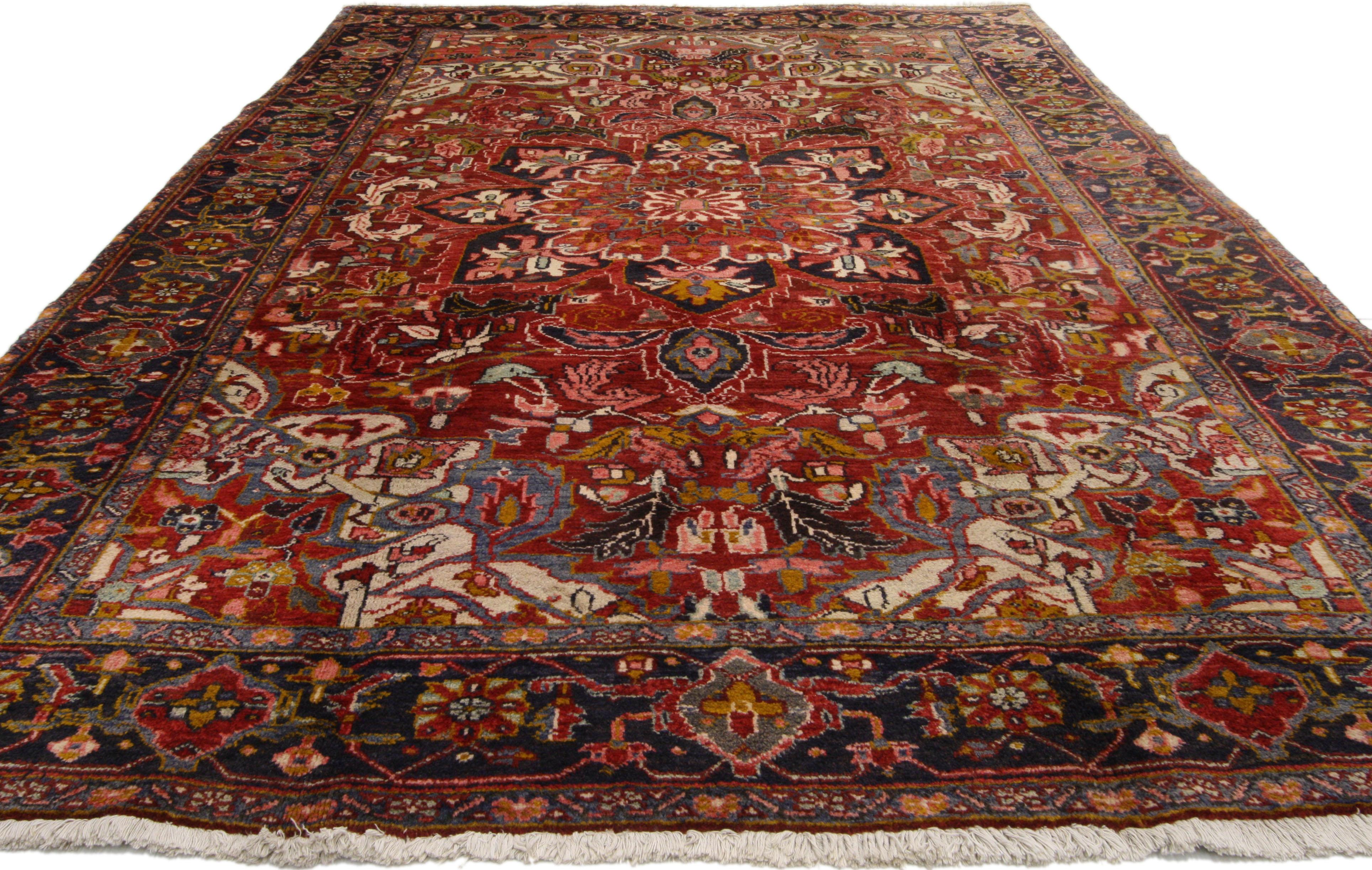 76223, vintage Persian Heriz rug with Mid-Century Modern style. Make a rich and dramatic statement while adding beauty and warmth to your home. This hand-knotted wool vintage Persian Heriz rug features a large floral center medallion surrounded by
