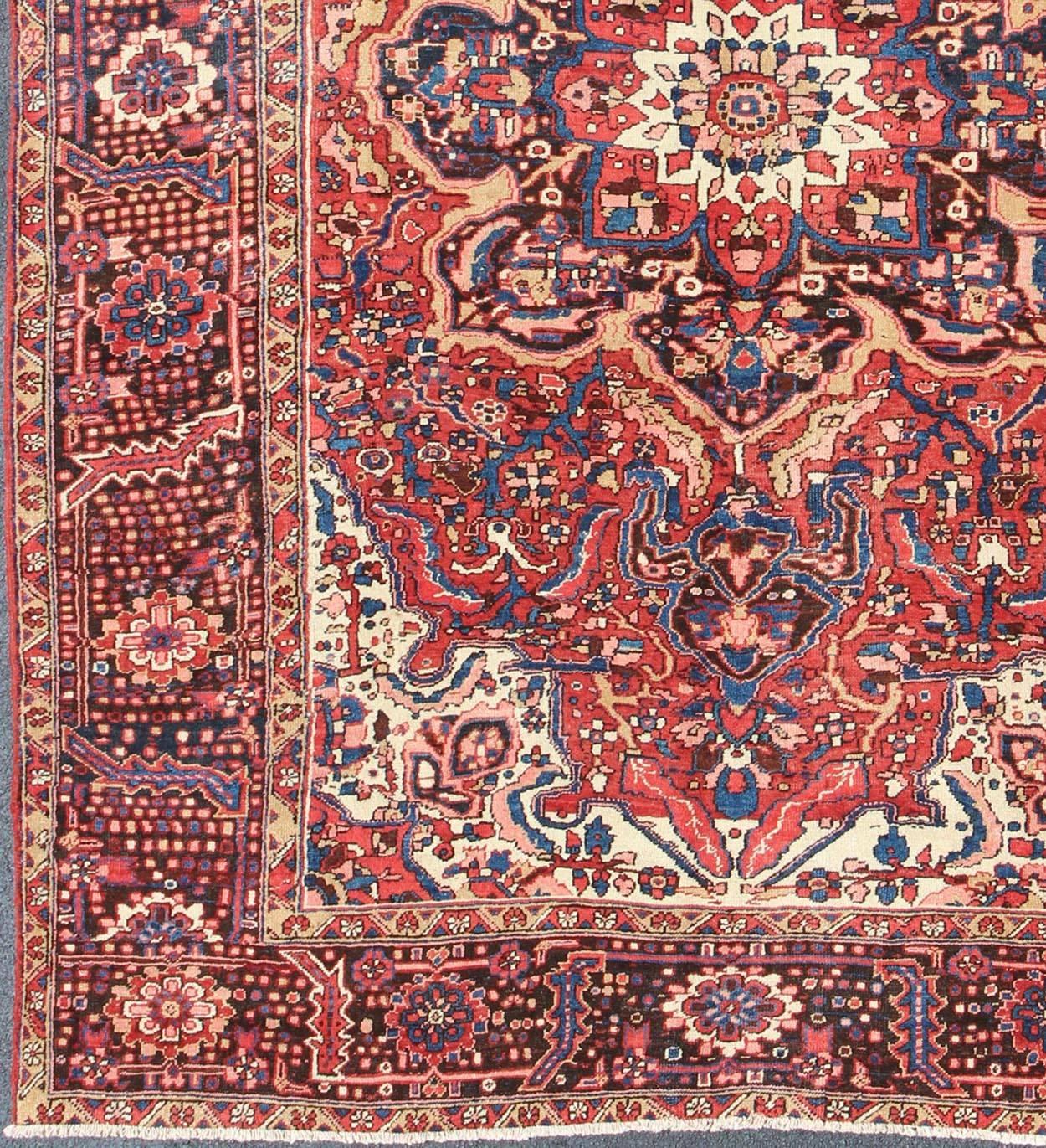Semi Antique Mid century Persian Heriz rug with stylized medallion design in red and blue, rug h-610-04, country of origin / type: Iran / Heriz, circa 1950.

This magnificent antique Persian Heriz carpet from the mid-20th century (circa 1950) bears