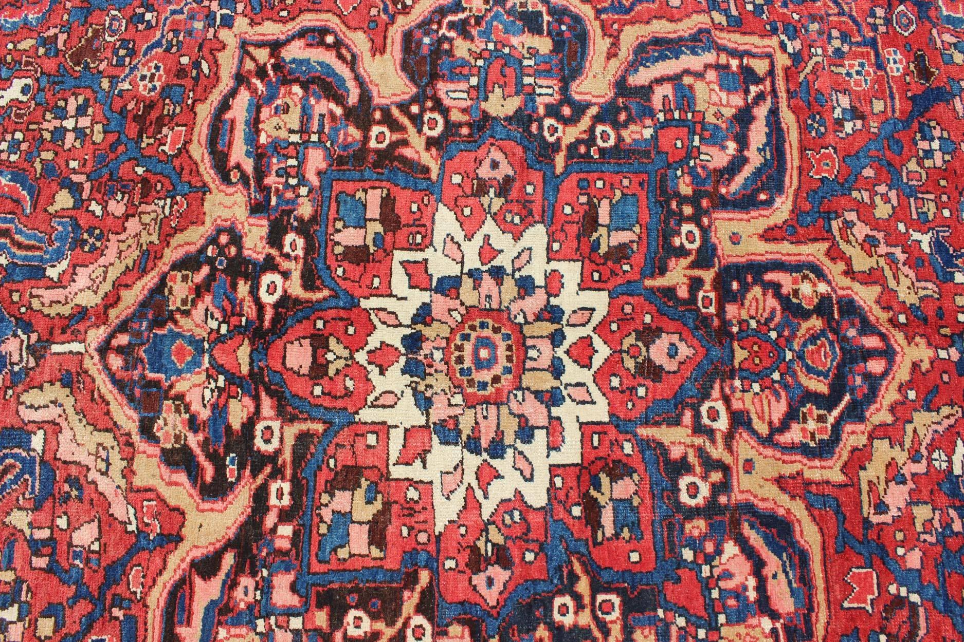 Mid-20th Century Semi Antique Persian Heriz Rug with Stylized Medallion Design in Red and Blue For Sale
