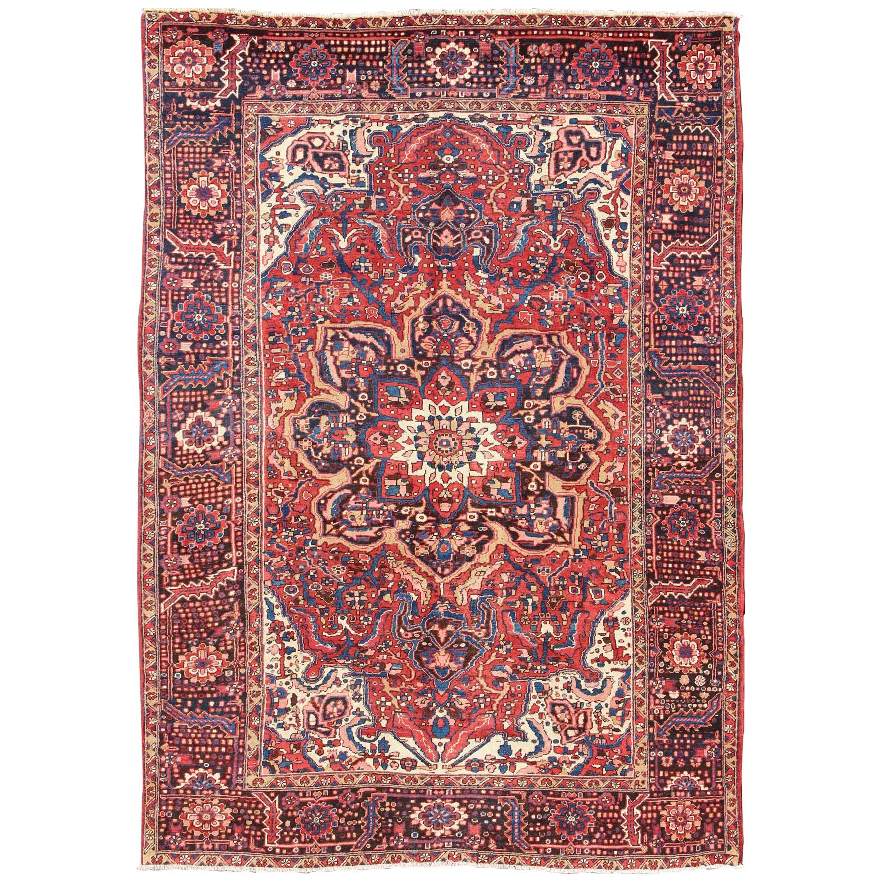 Semi Antique Persian Heriz Rug with Stylized Medallion Design in Red and Blue For Sale
