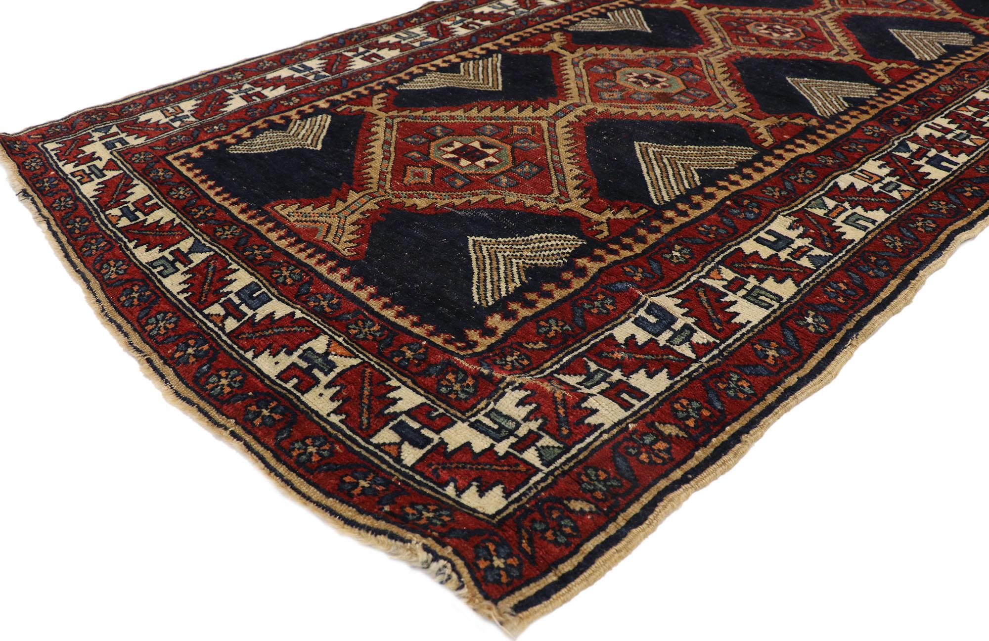 77396 Vintage Persian Heriz runner with Mid-Century Modern style. This hand knotted wool vintage Persian Heriz runner features a center column of diamond-shaped pole medallions spread across an abrashed ink blue field. Each medallion contains a