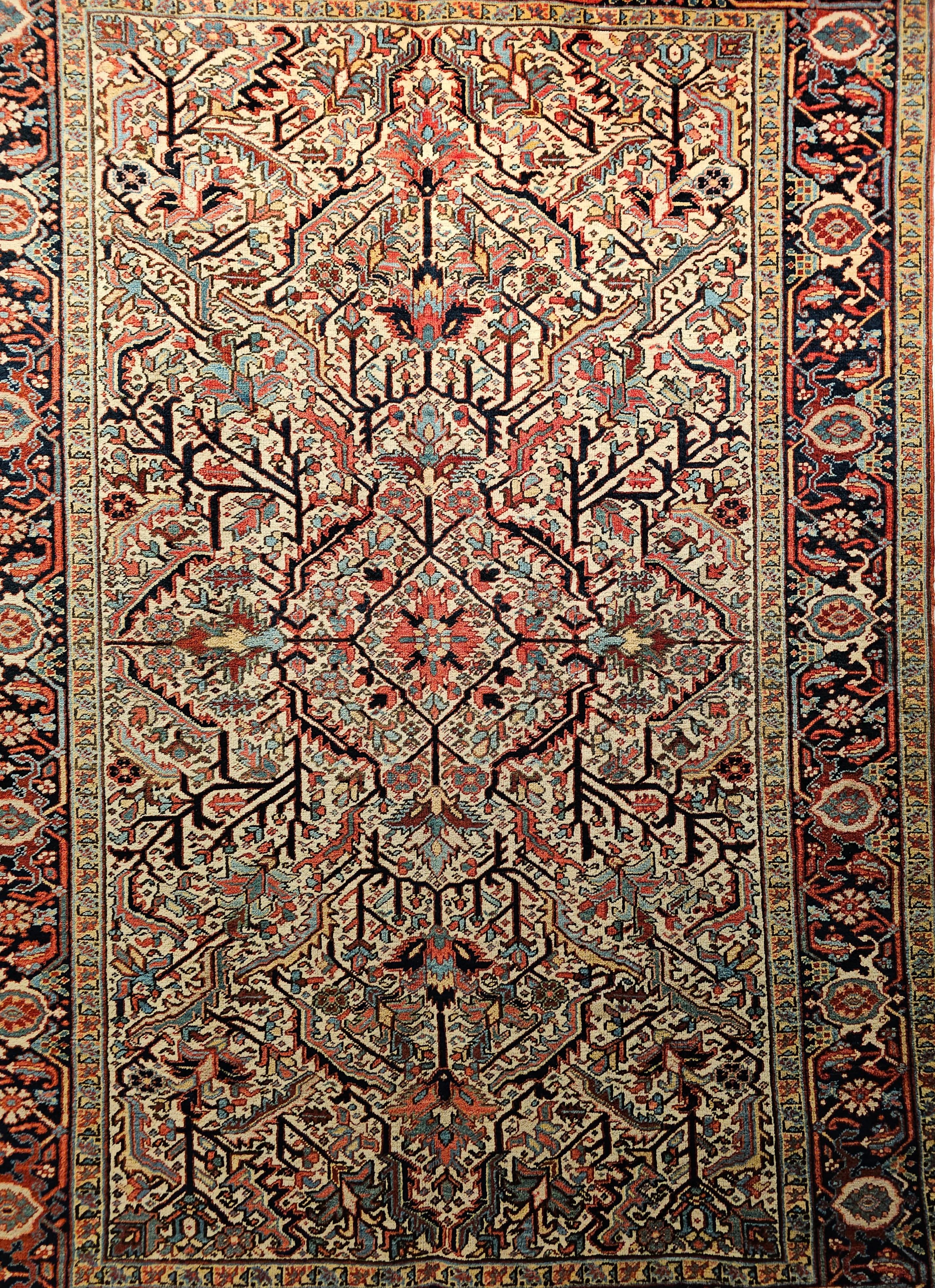 A vintage Persian Heriz Serapi with an allover “Tree of Life” design on a pale yellow field. This beautiful Heriz rug was woven in a village in the Azerbaijan district of NW Persia in the first quarter of the 1900s. It has a few very unique and