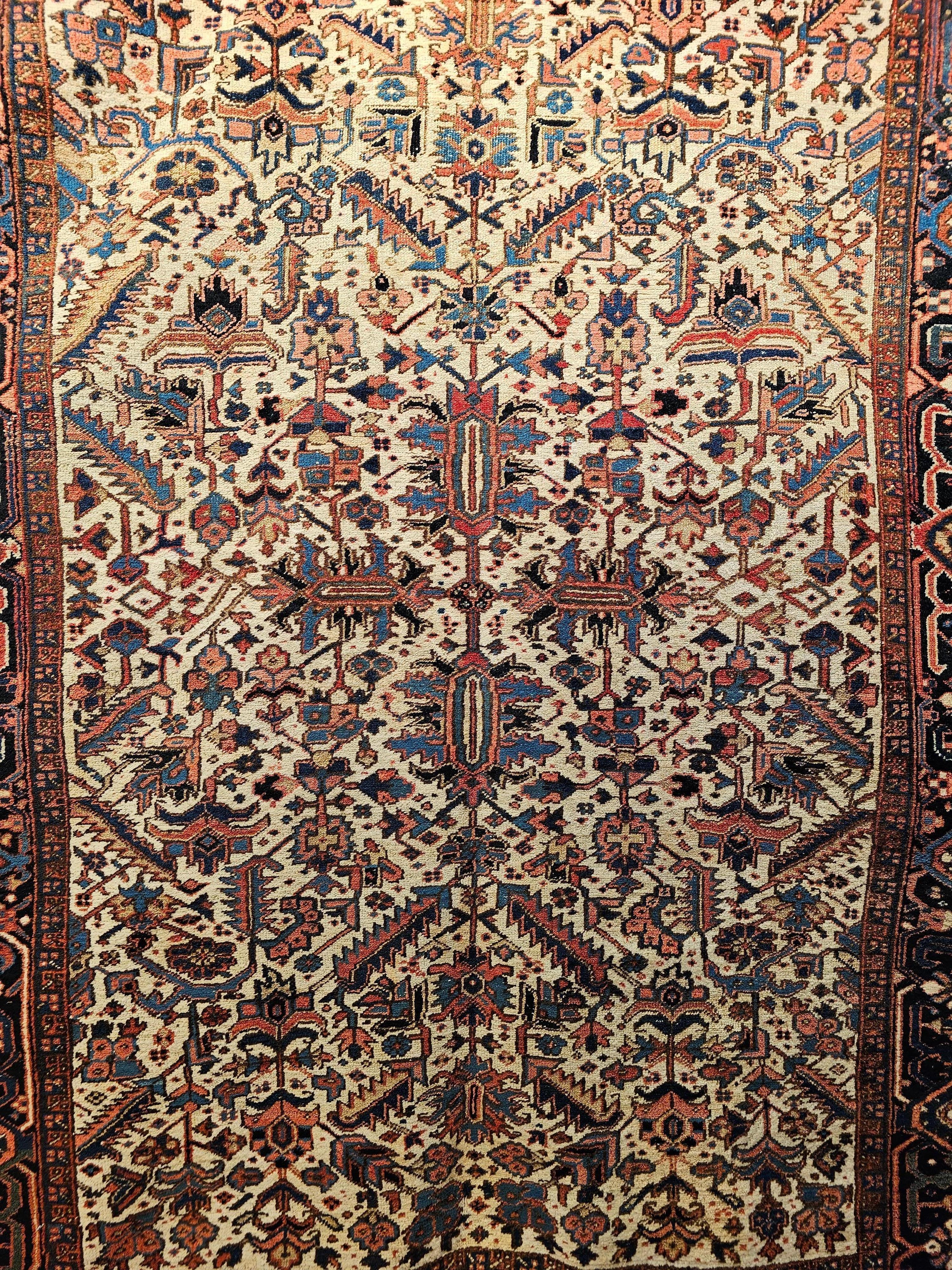 The beautiful Heriz with Serapi colors is in an all over pattern set on an ivory color field. This beautiful Heriz rug was woven in a village in the Azerbaijan district of NW Persia in the first quarter of the 1900s. It has a few very unique and