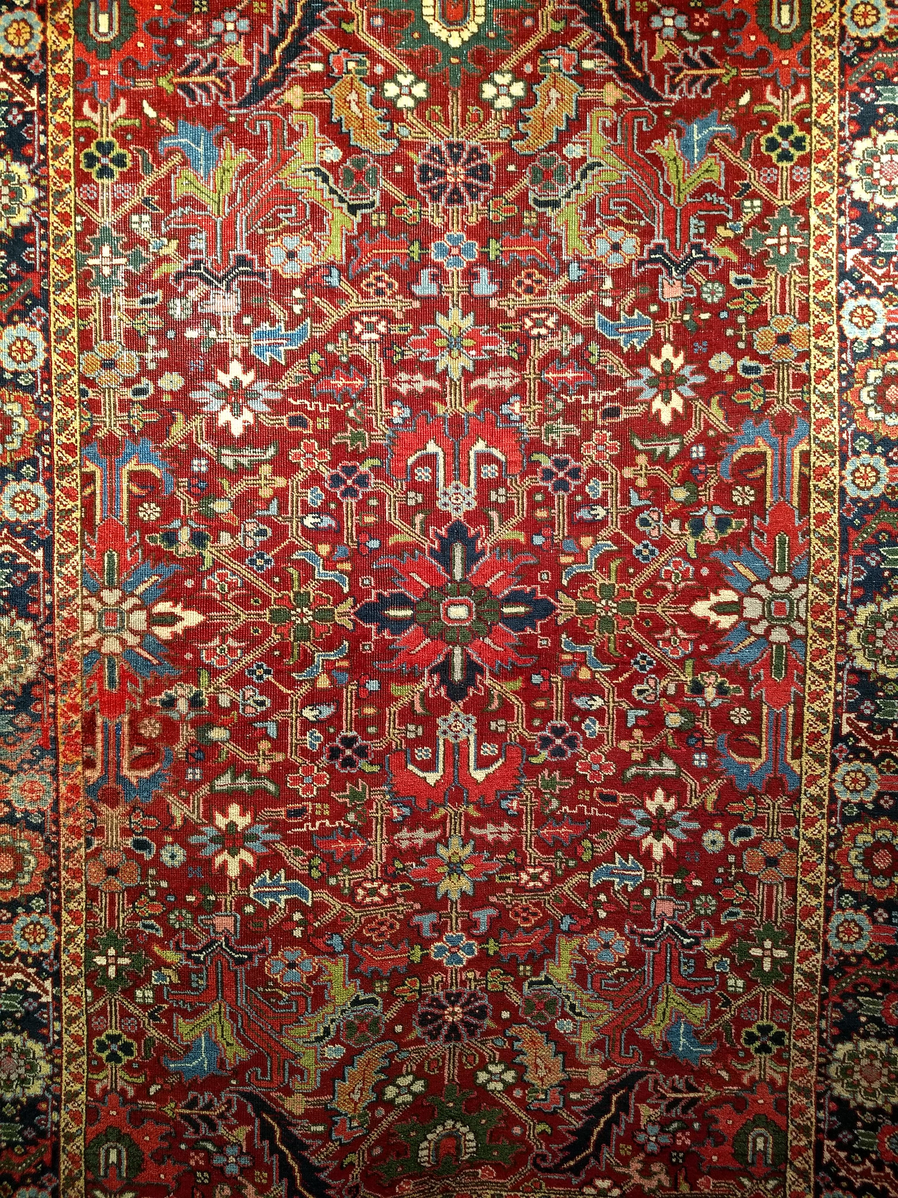  A beautiful and colorful Persian Heriz Serapi from the early 1900s.  The rug has a special uniqueness in having an allover design, and wonderful colors which makes this an extremely rare and very desirable room-size rug.  The beautiful Heriz Serapi