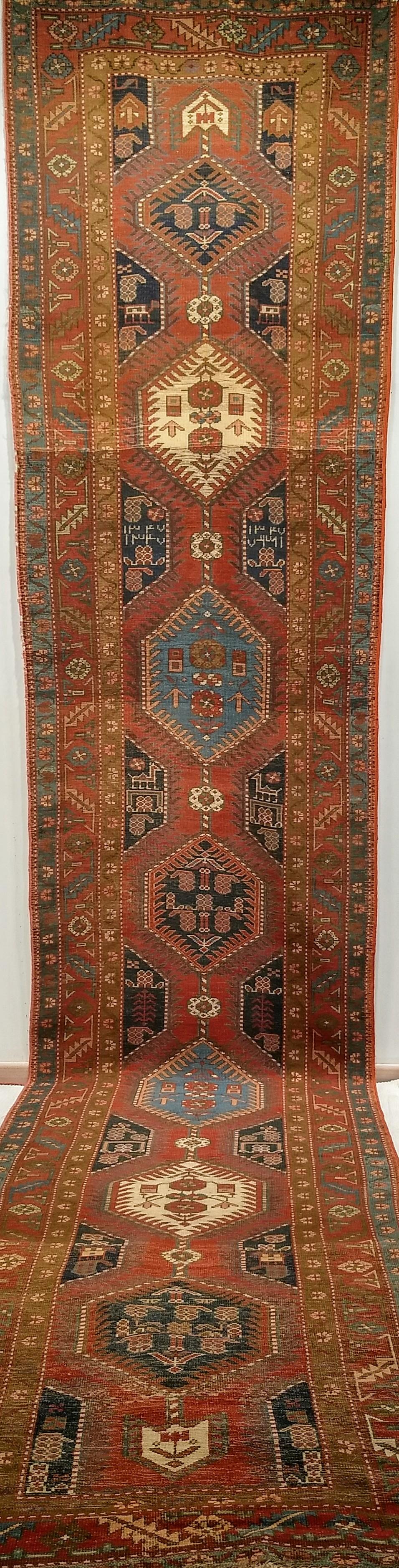 Un affascinante runner Heriz Serapi antico dell'inizio del XX secolo, tessuto a mano nella Persia nord-occidentale e datato 1327 nel calendario islamico (circa inizio 1900). Questo runner di grande formato presenta un audace ed equilibrato disegno