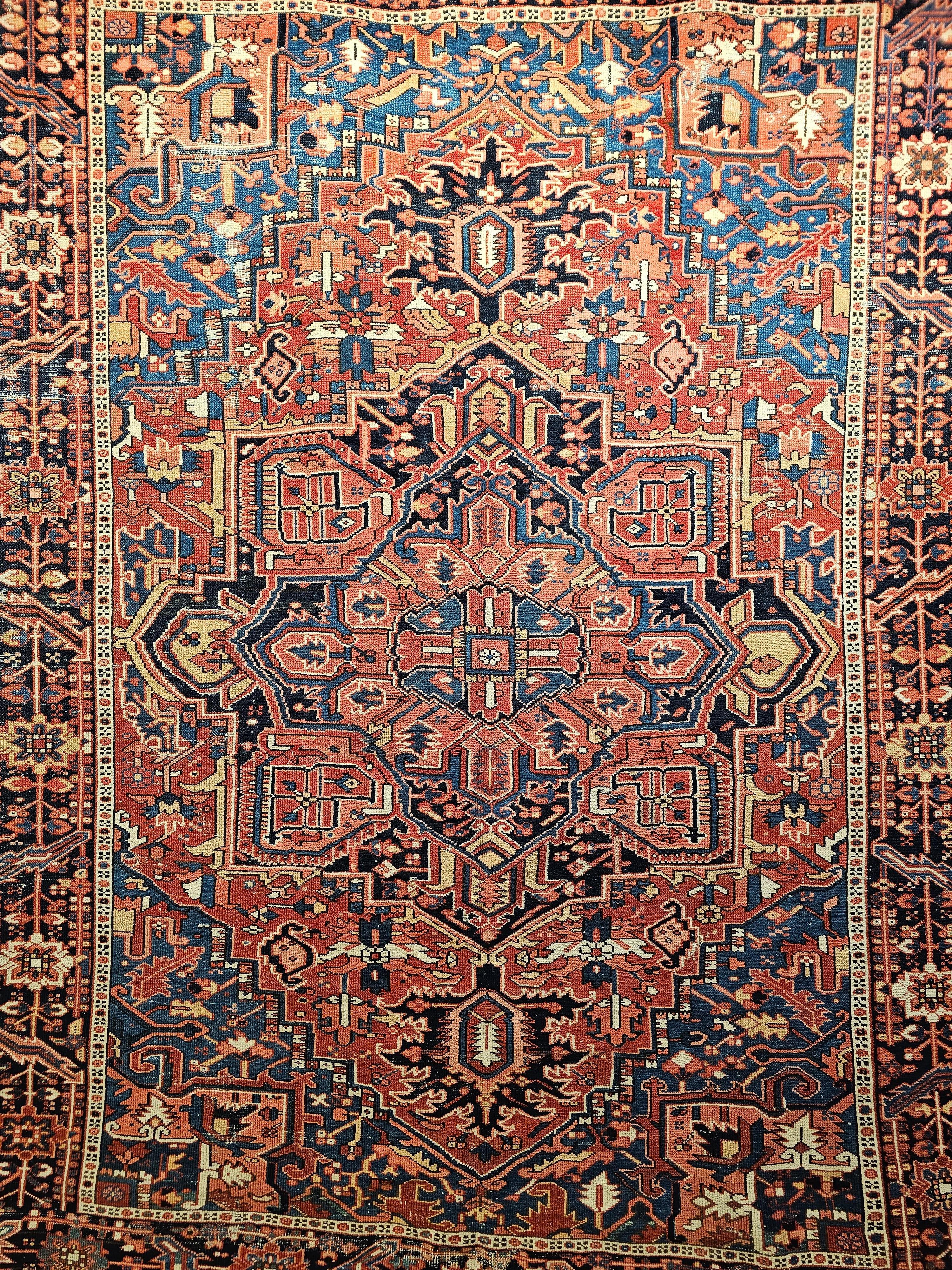 Vintage Persian Heriz Serapi with abrash French blue and yellow colors from NW Persia from the late 1800s. The abrash French Blue and yellow colors in the field truly stand out. The rug has dark red field color with corner spandrels in beautiful