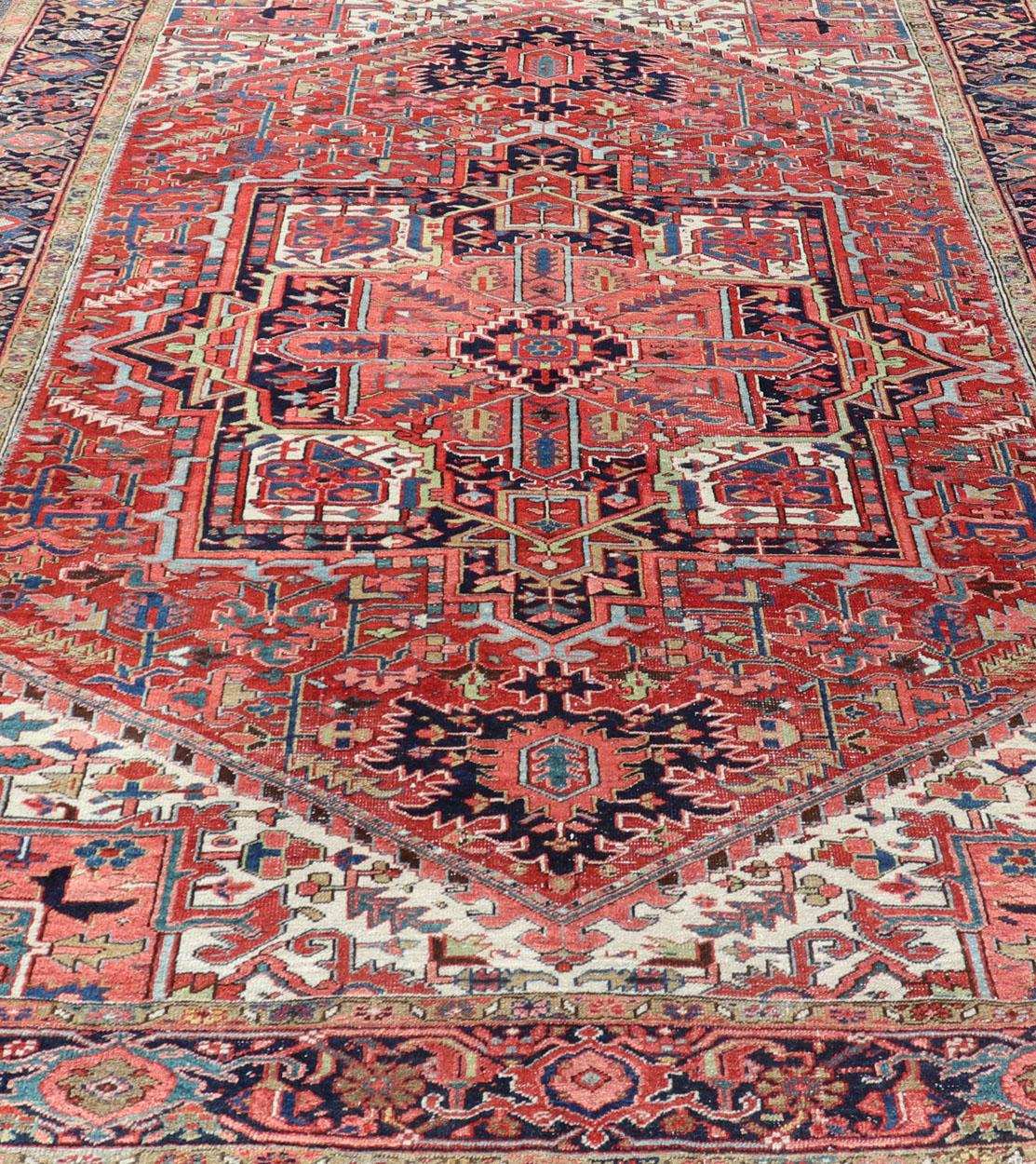 Hand-Knotted Antique Persian Heriz with Central Medallion Design in Red and Jewel Tones For Sale