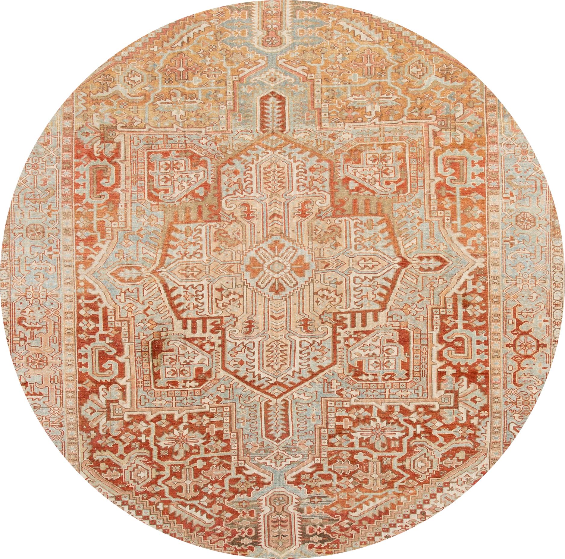 Beautiful Heriz hand knotted wool rug with a peach field and gray frame. This rug has multi-color accents in all-over geometric floral medallion design. 

This rug measures 8' 2