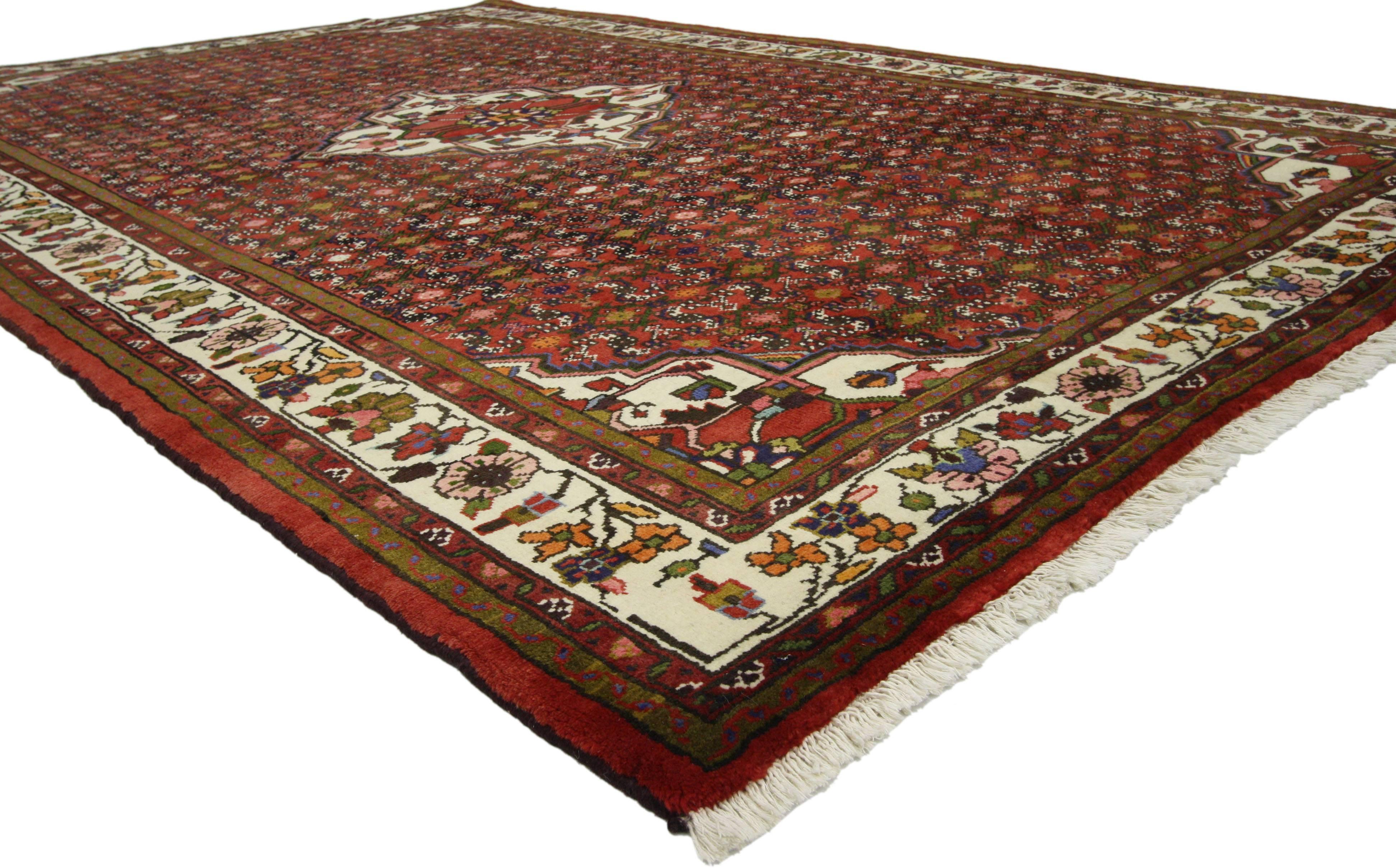 76028 Vintage Persian Hosseinabad rug with Tudor Manor House style. This hand knotted wool vintage Persian Hosseinabad rug features a cusped diamond center medallion surrounded by the all-over Classic Herati design. The all-over Herati pattern is