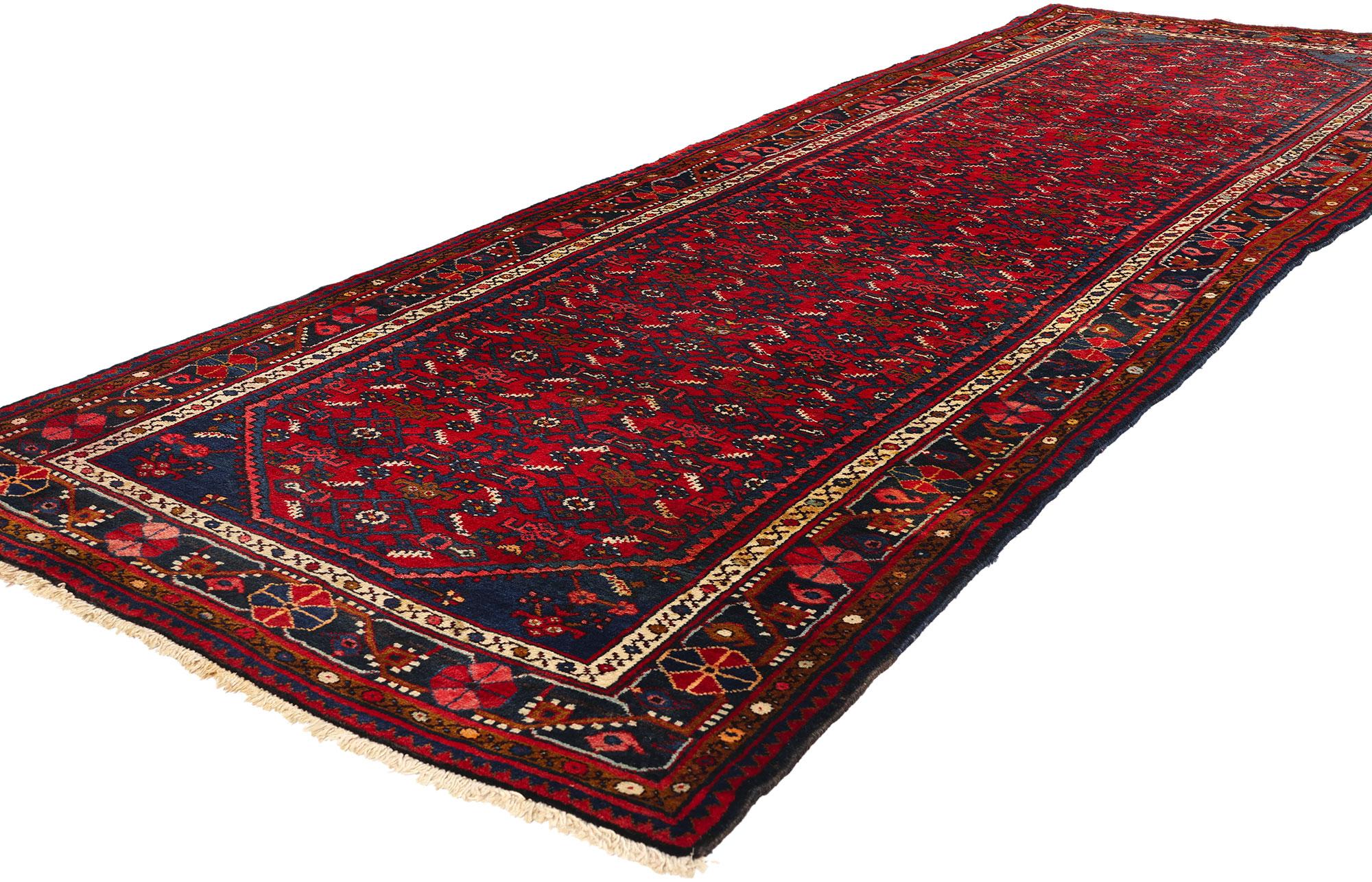 76135 Vintage Persian Hamadan Rug Runner, 03'09 X 10'10.  Crafted with meticulous care, this vintage Persian Hussainabad Hamadan runner showcases a captivating all-over Herati pattern woven into its abrashed red field. The intricate Herati motif,