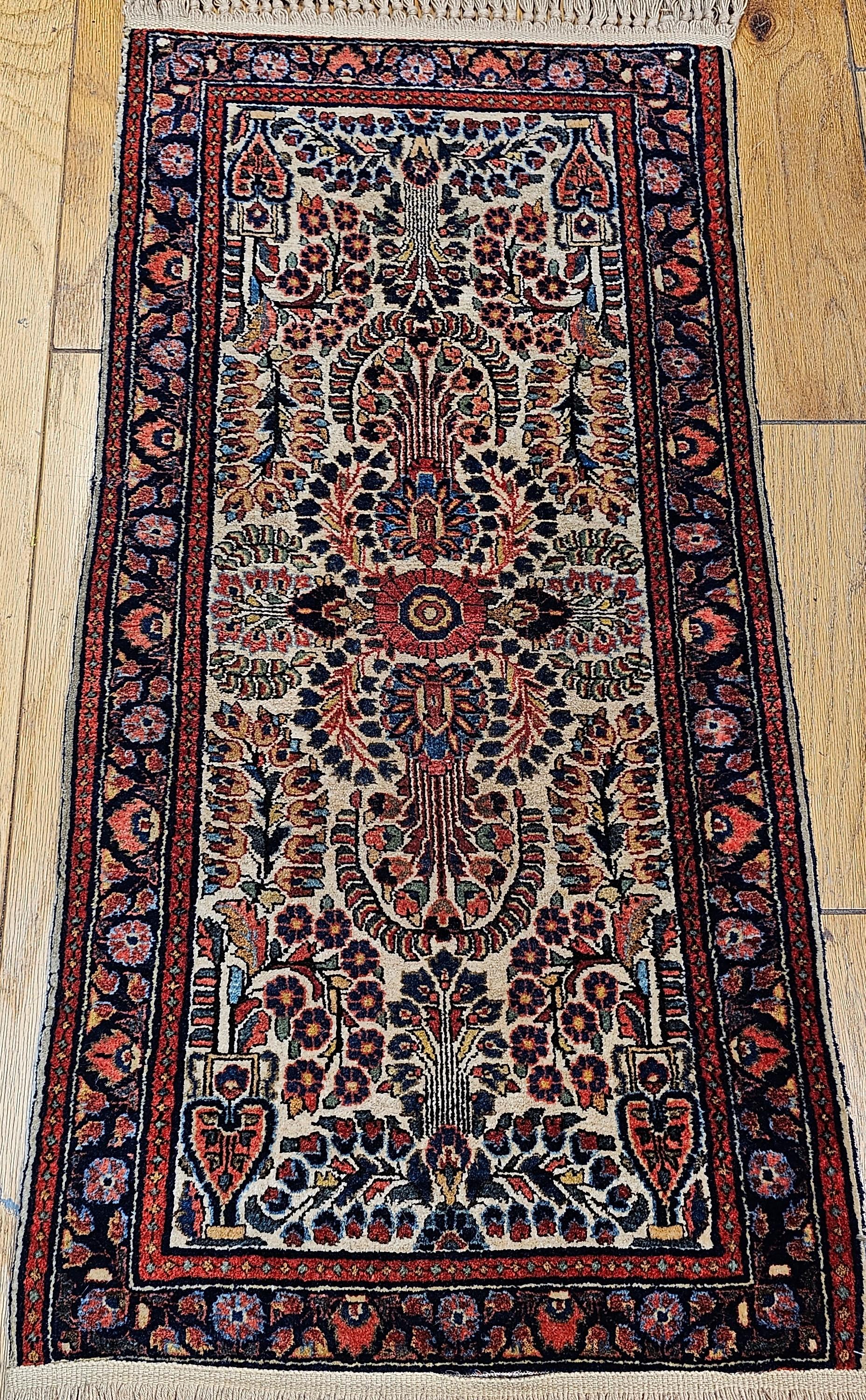 Vintage Ivory color Persian Sarouk area rug from the second quarter of the 1900s.  The ivory color Sarouk is very rare and extremely desirable.  The rug has an allover pattern with designs in yellow, blue, red, pink and green.
Dimensions:  2’ x