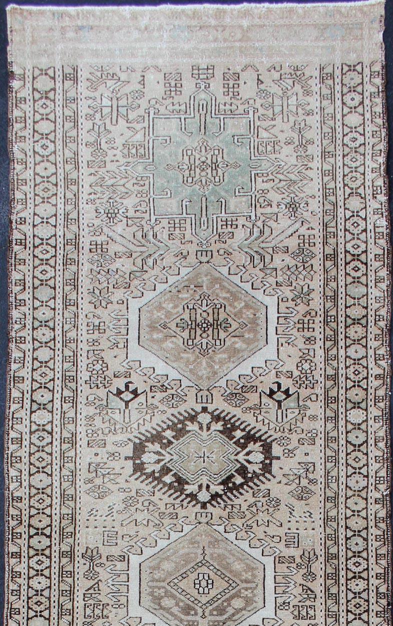 Karadjeh vintage Persian Runner with multi-medallion design from Persia in light taupe/blush background and brown, blue accent colors and highlights, rug 510-35, country of origin / type: Iran / Karadjeh, circa mid-20th century

This magnificent