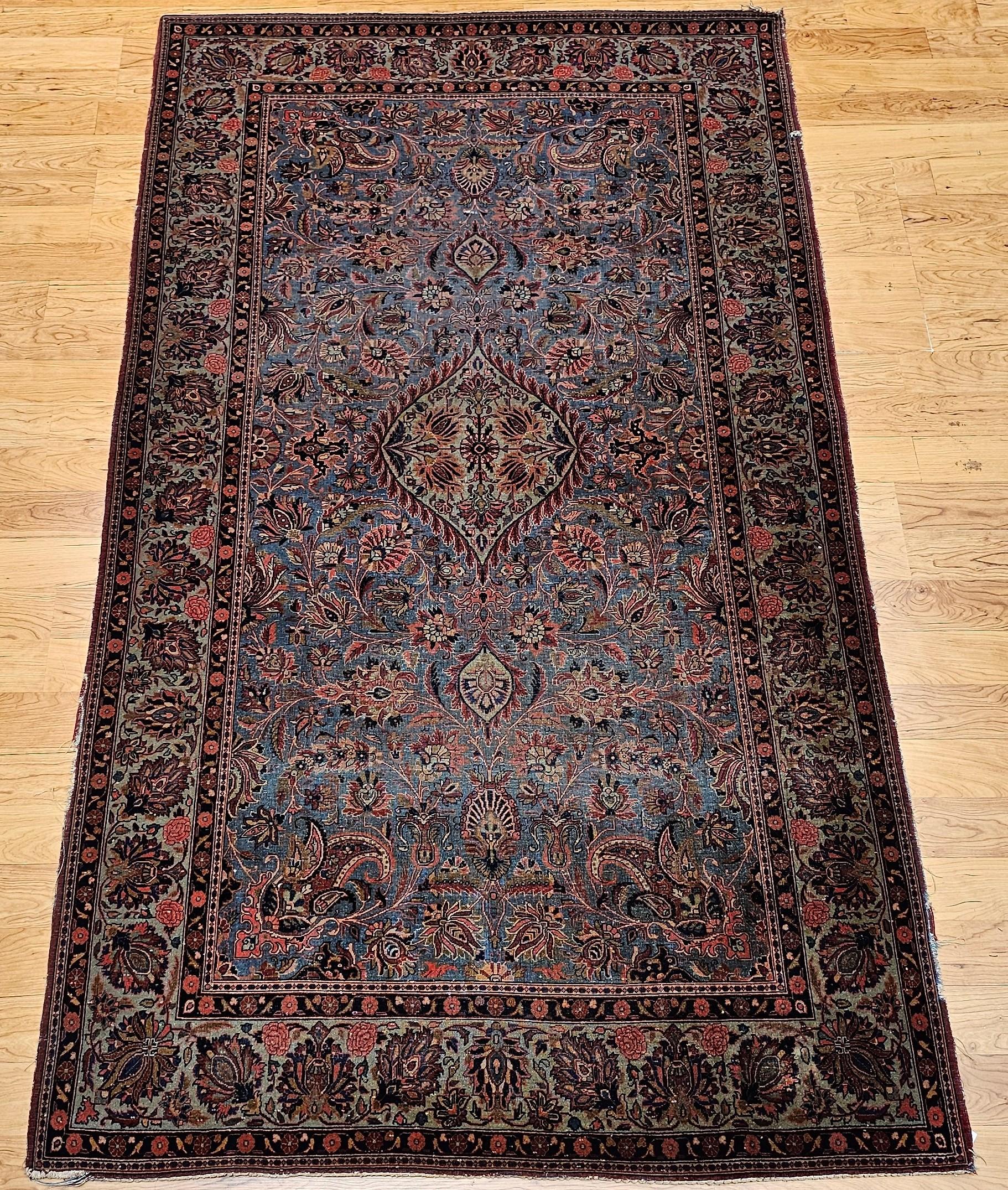 Alfombra persa Kashan de época, anudada a mano, con motivos florales sobre un maravilloso campo azul aguamarina y un borde verde azulado, de principios del siglo XX.  El diseño contiene motivos de hojas, palmetas y enredaderas con un borde de