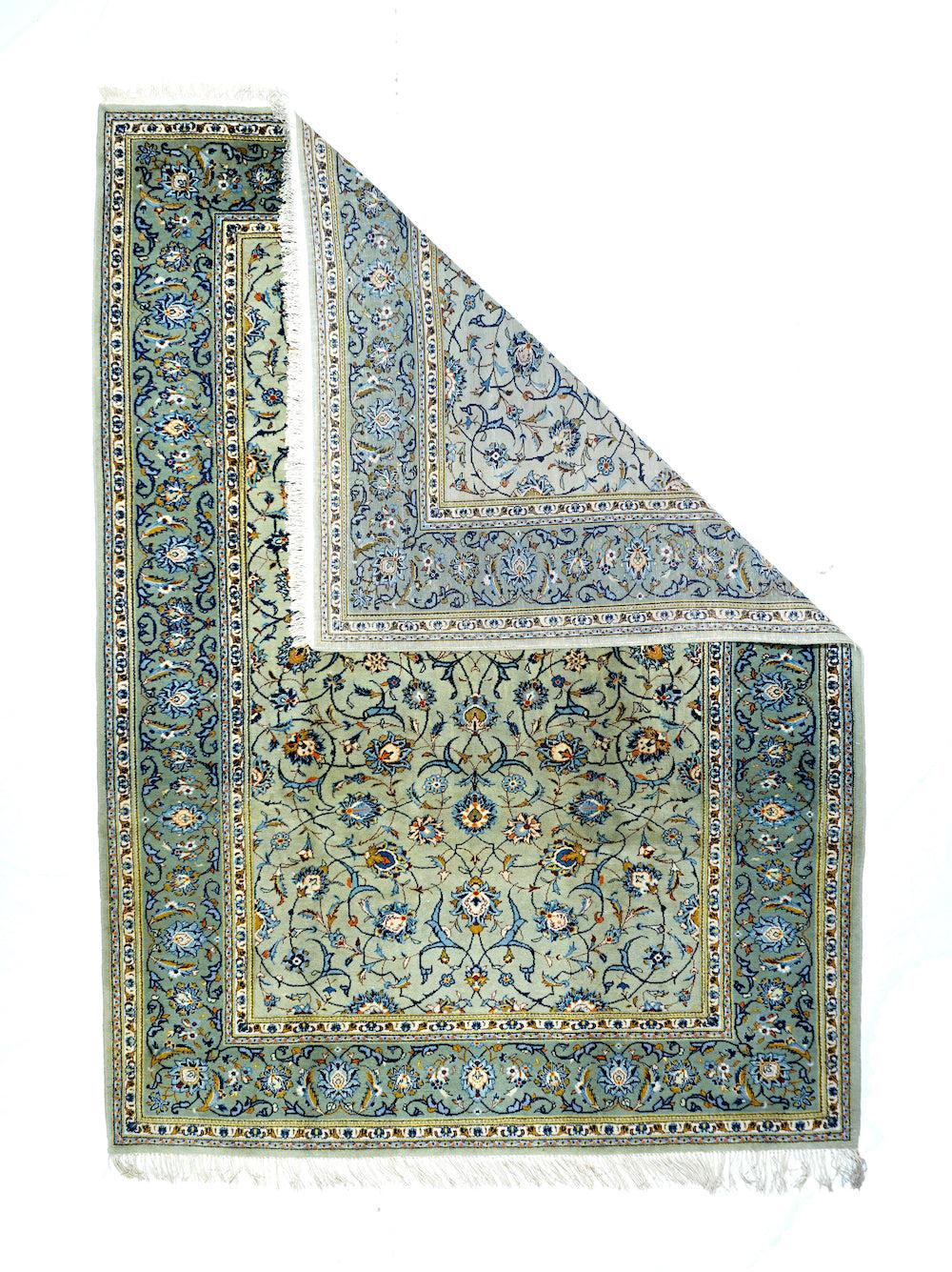 Vintage Persian Kashan Rug 7'3'' x 10'4''.  Shades of light and royal blue accent the peal palmettes, forked arabesques and two-level vinery adorning the putty ground of this centrally organized central Persian finely woven city carpet. Green border
