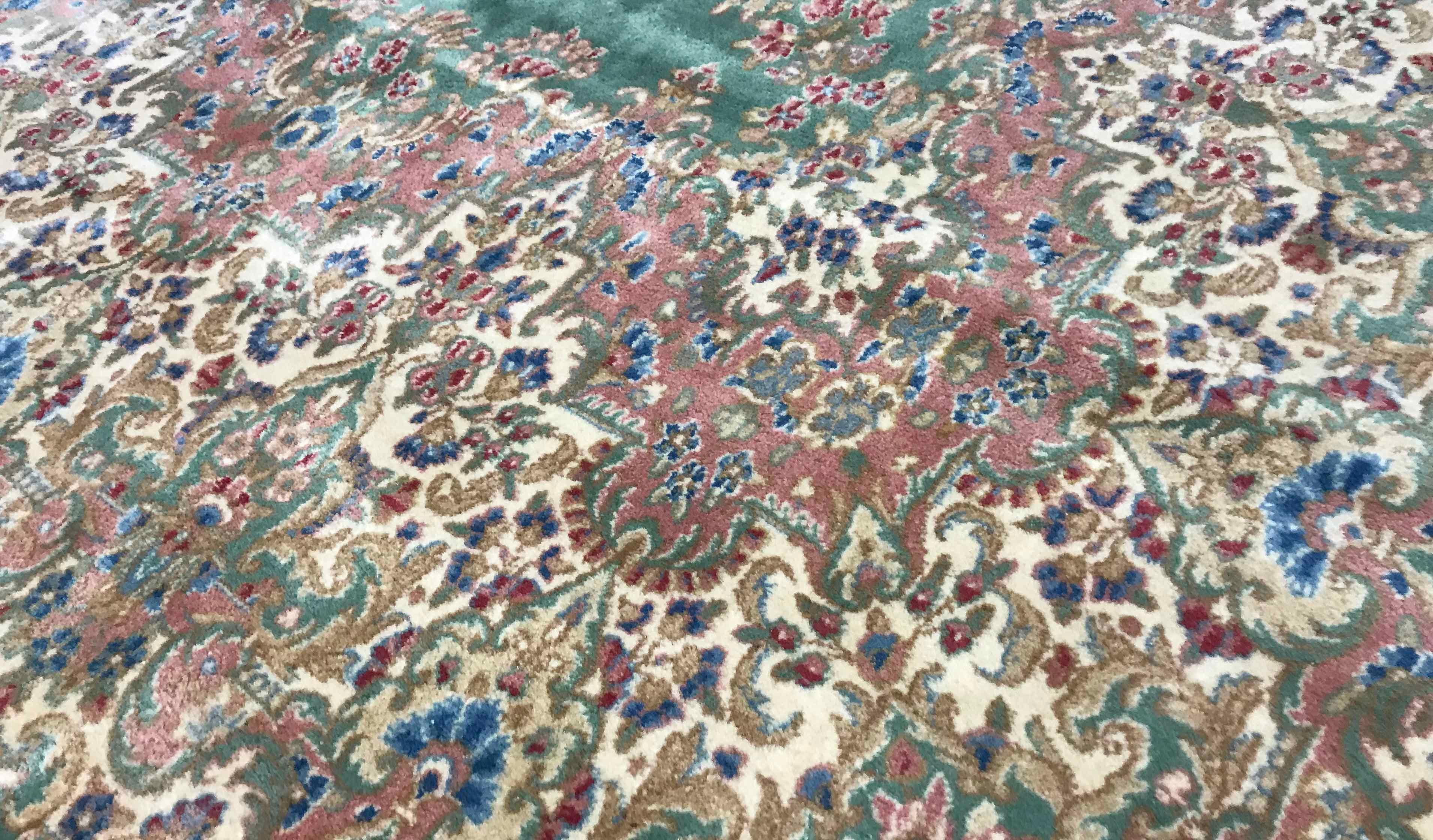 Vintage Persian Kerman, circa 1940. A delightful color combination of soft pastel shades is incorporated in this Kerman rug with the soft green field enclosing a central medallion in soft pastel colors with floral designs repeated around the sides