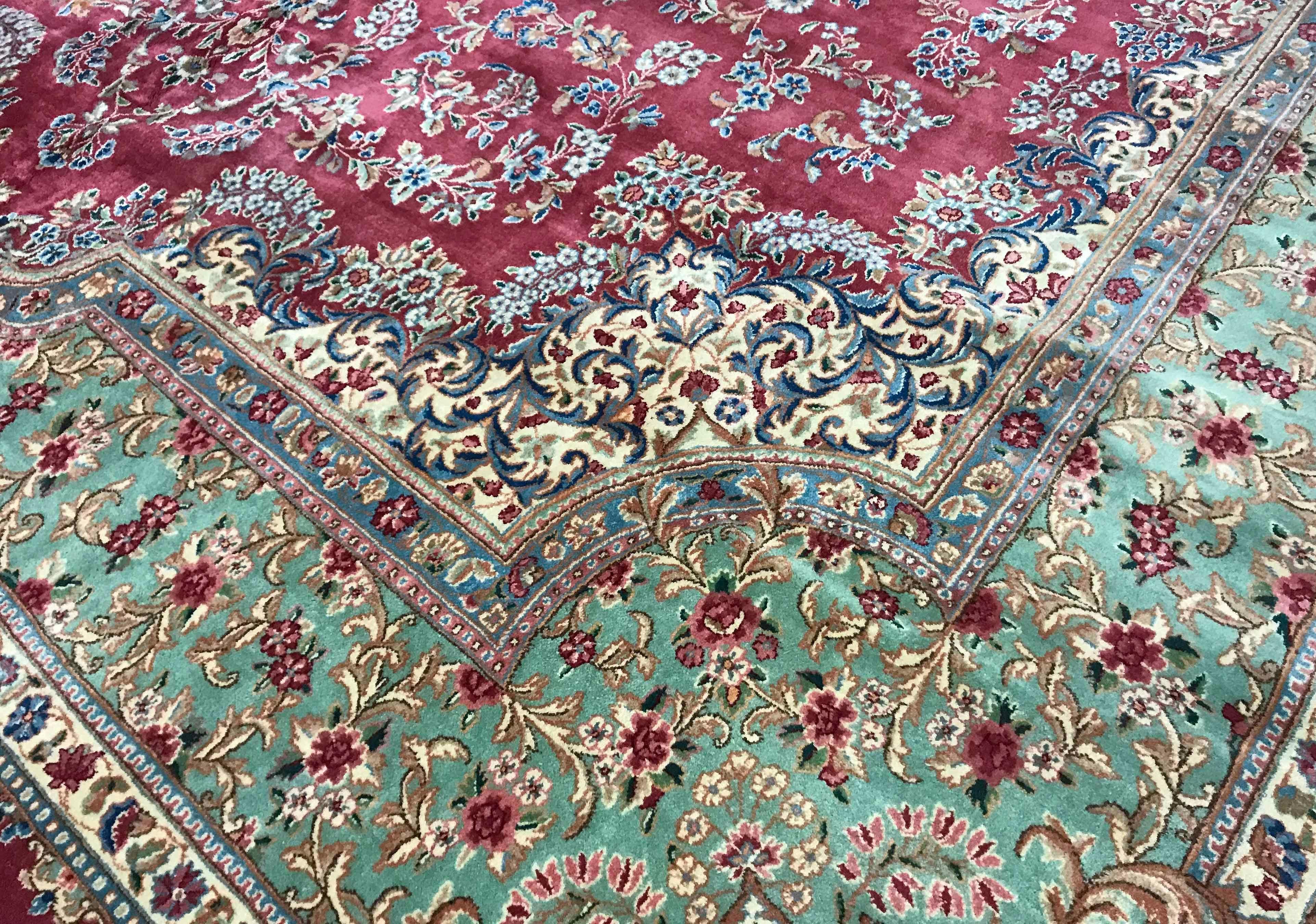 Vintage Persian Kerman, circa 1940. A delightful Kerman rug woven with exquisite detail, the red ground filled with weaving floral designs surrounding a central ivory and soft blue medallion bounded by a soft green main border and ivory and blue