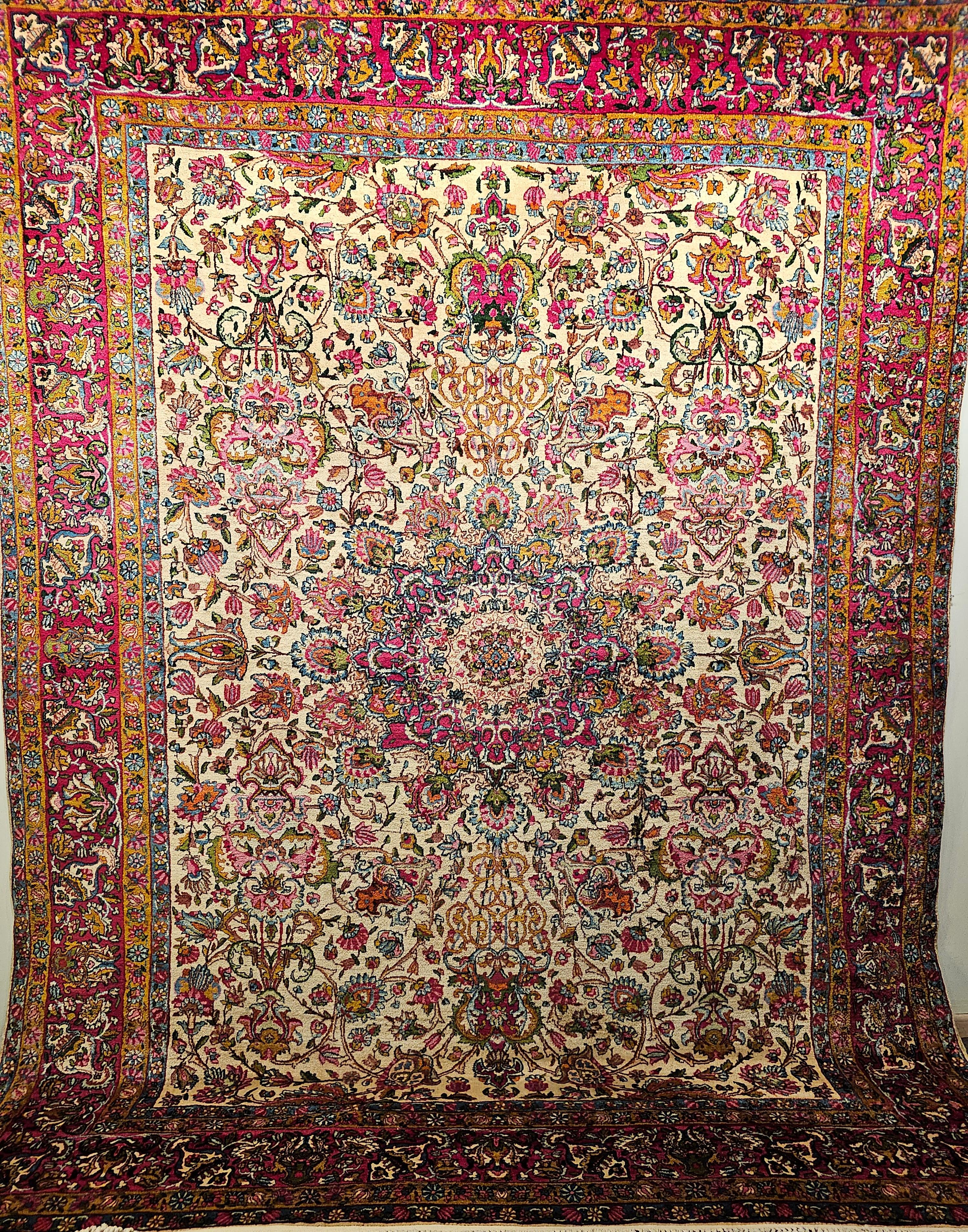 Astonishingly beautiful and colorful Persian Kerman Lavar room size rug in floral design in ivory background with design colors in red, pink, green, blue and many others.  The rug has a gorgeous design and wonderful color combination.  The rug has