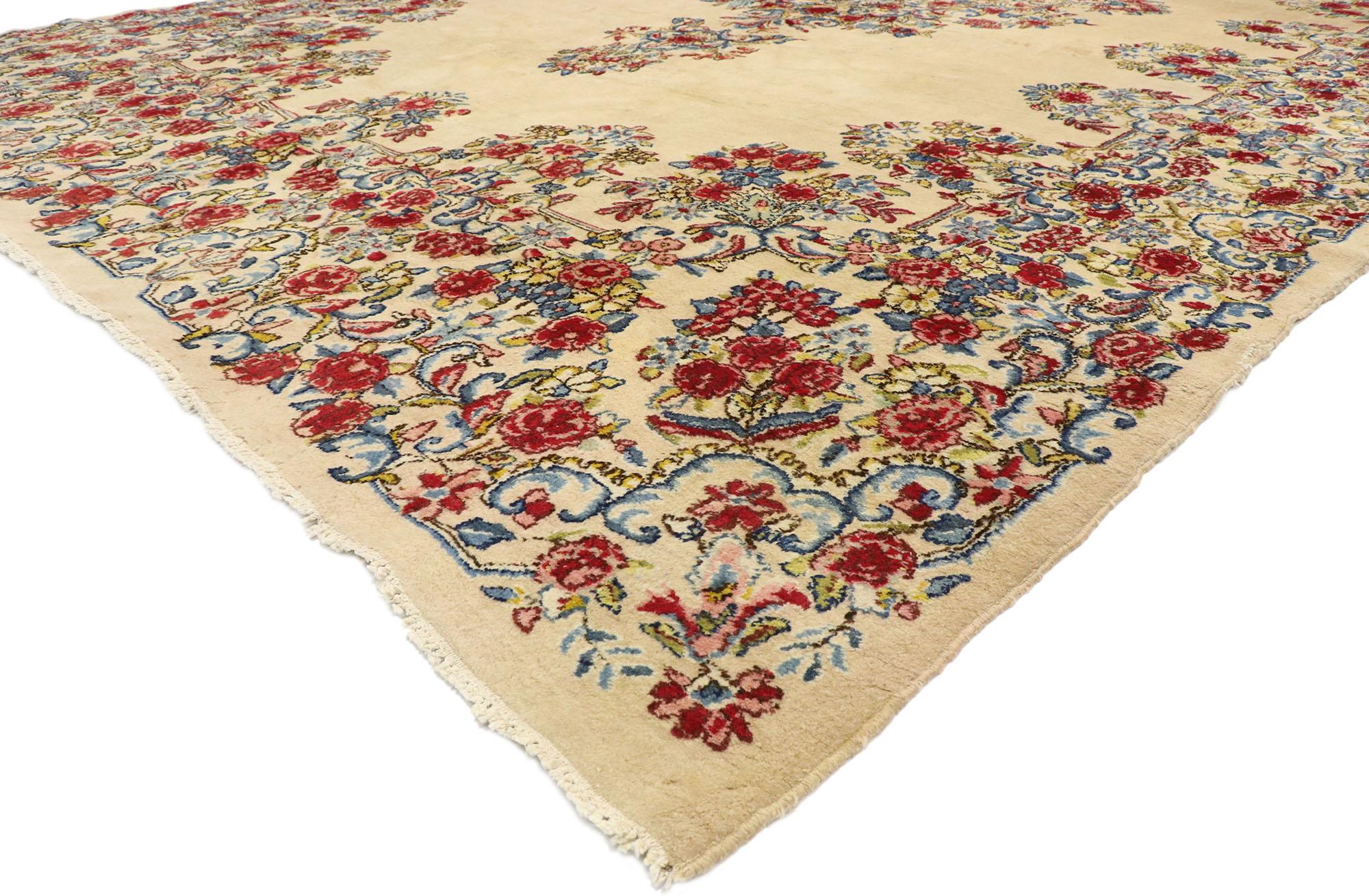 74919 vintage Kirman Palace size rug with Romantic French Provincial style. This hand knotted wool vintage Persian palace rug features a Classic Kerman Medallion design composed of delicate flowers in an open field. The elaborate Kerman medallion is