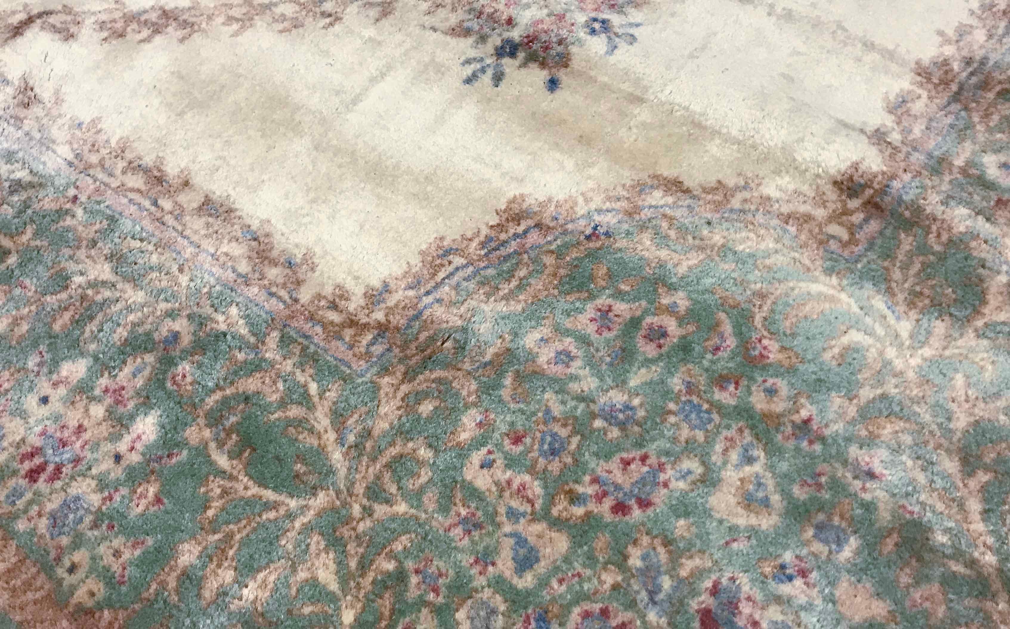 On an ivory field the central floral design surrounded by repeating patterns is enclosed within a soft green border to create a calm feel that will fit into many vintage Persian Kerman Ivory / Green rug circa 1940 different rooms and styles. Size: