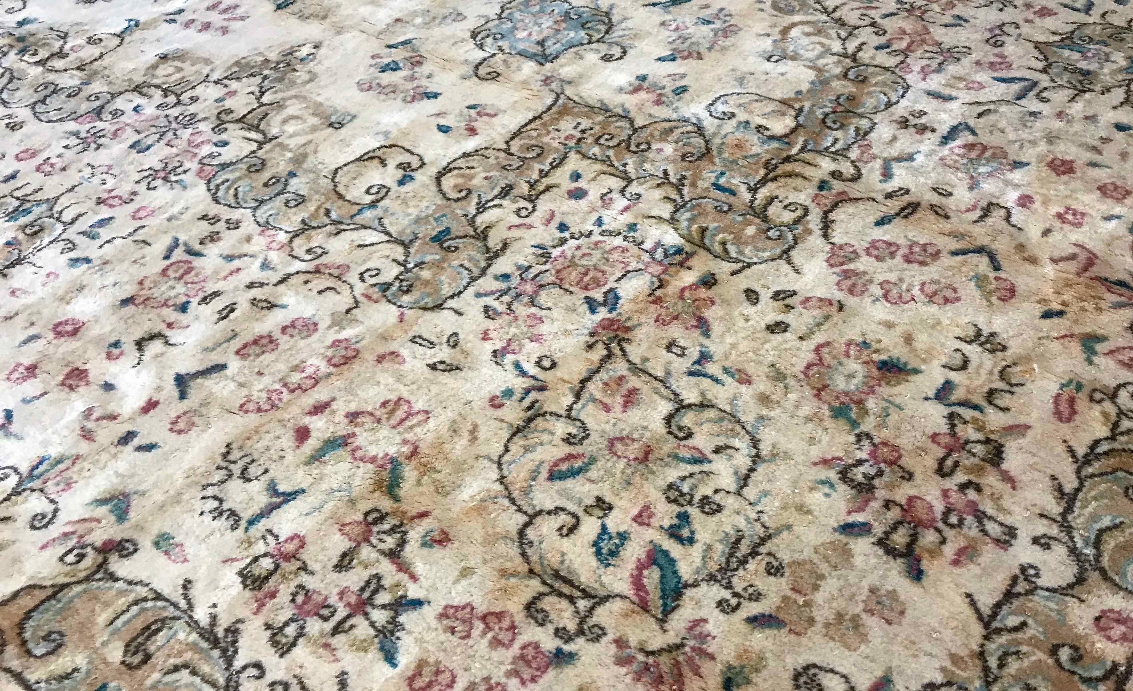 Vintage Persian Kerman rug, circa 1940. A soft and gentle design on an ivory field which blends into the border to create this large handwoven Kerman rug from Persia. Size: 11'5 x 20'11.