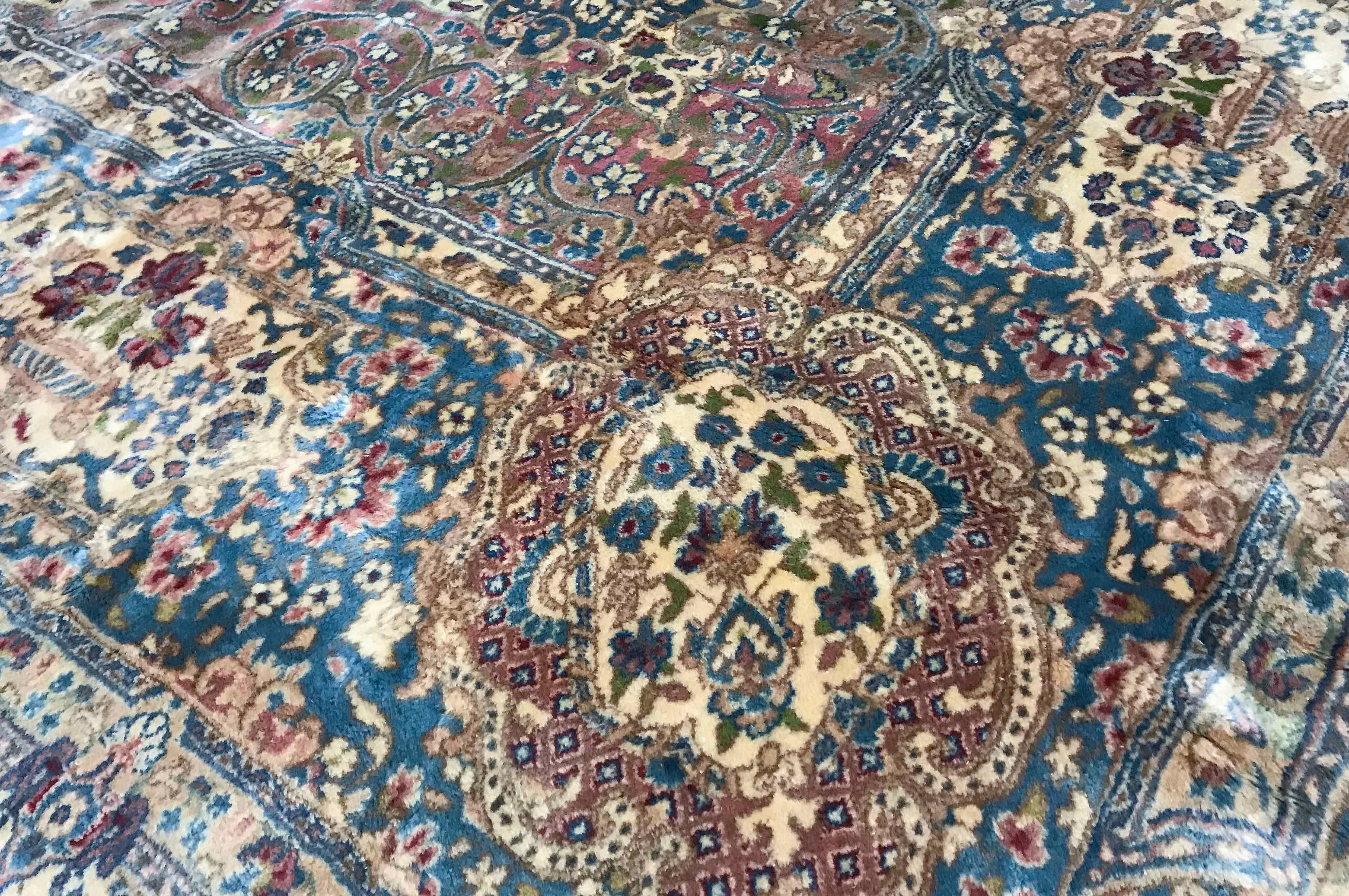 Vintage Persian Kerman rug, circa 1940. The soft ivory ground is the setting for this picturesque rug with a central medallion which blue colors and style is repeated in the borders to create this large but gentle looking rug. Size: 12'6 x 21'.