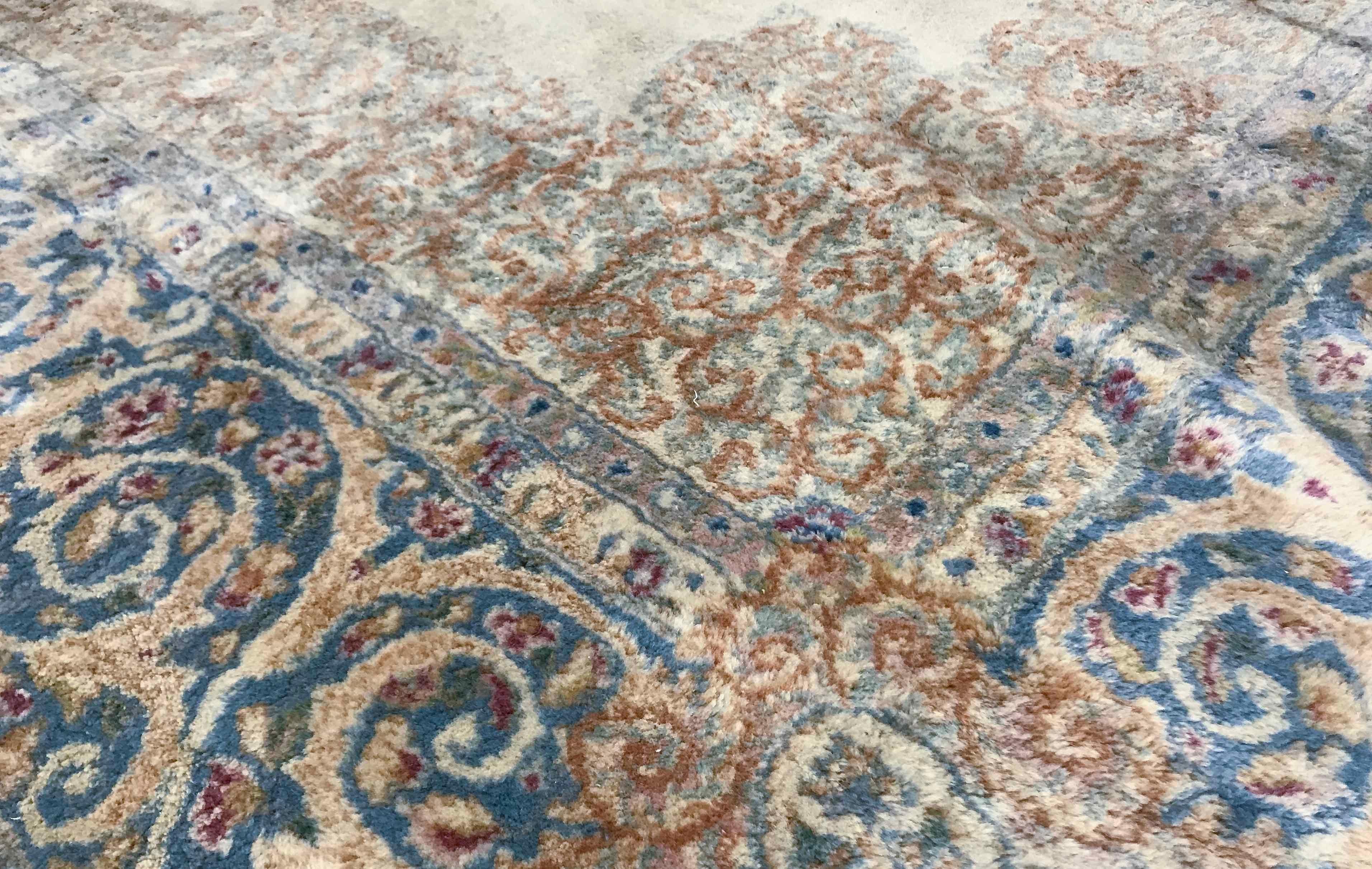 Vintage Persian Kerman rug, circa 1940. A Classic look to this Kerman rug with a soft ivory field with a central floral medallion surrounded by a main border repeating the colors and designs. The softness of this piece will make a tranquil setting