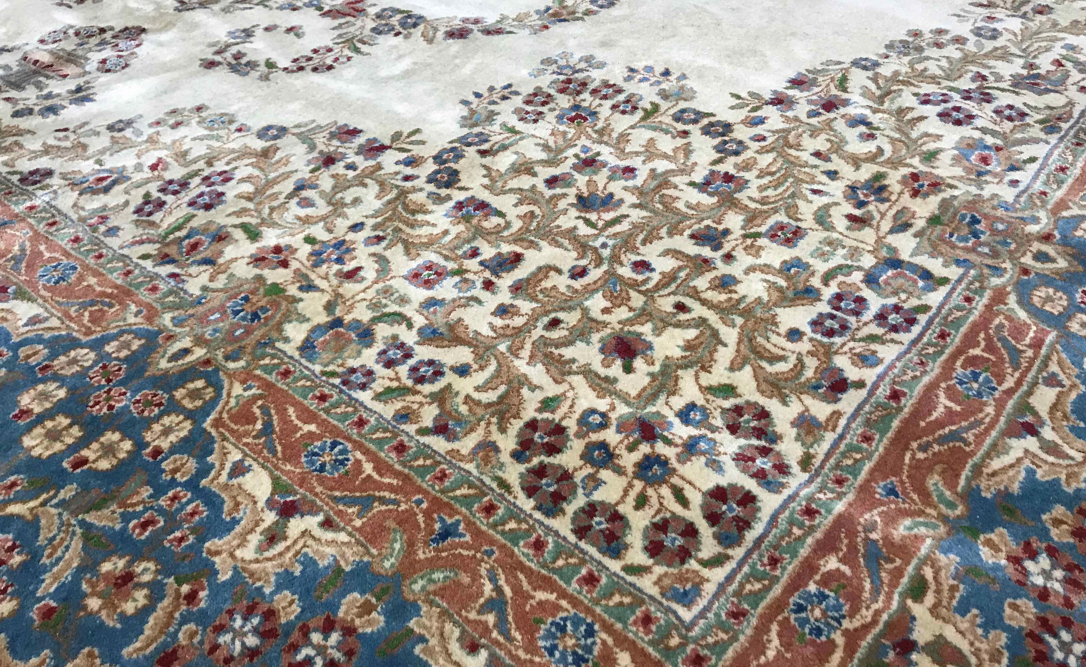 Vintage Persian Kerman rug, circa 1940. A wonderful design to this vintage 1940s Kerman rug, the central ivory field enclosing a soft blue floral themed medallion surrounded by swirls of detailed floriated patterns and then repeated in the
