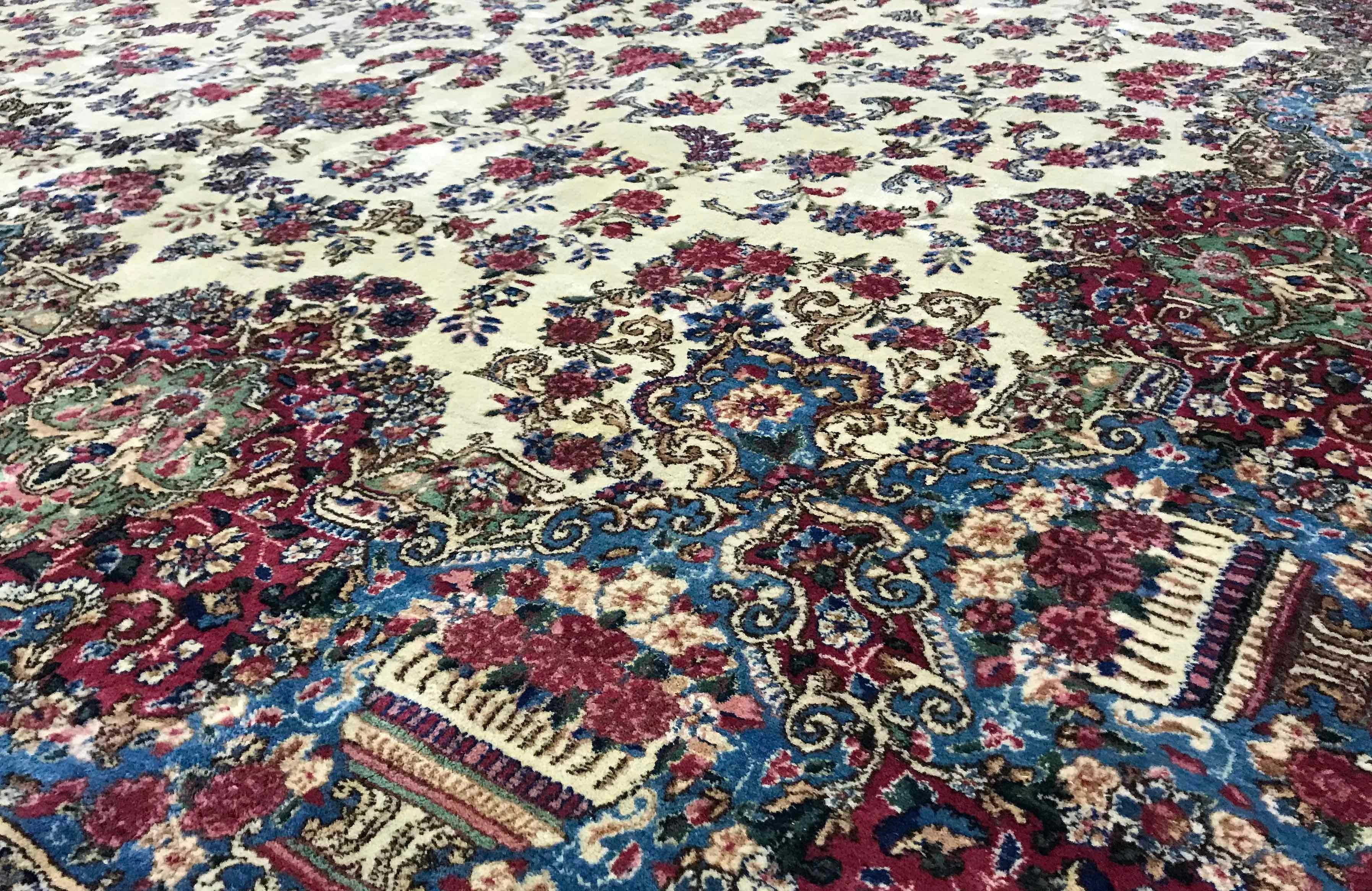 Vintage Persian Kerman rug, circa 1940. This rug has a wonderfully soft central filed, filled with floral designs surrounding a central medallion in soft blues that extends into the border to create a relaxed and gentle feel to this 1940s vintage