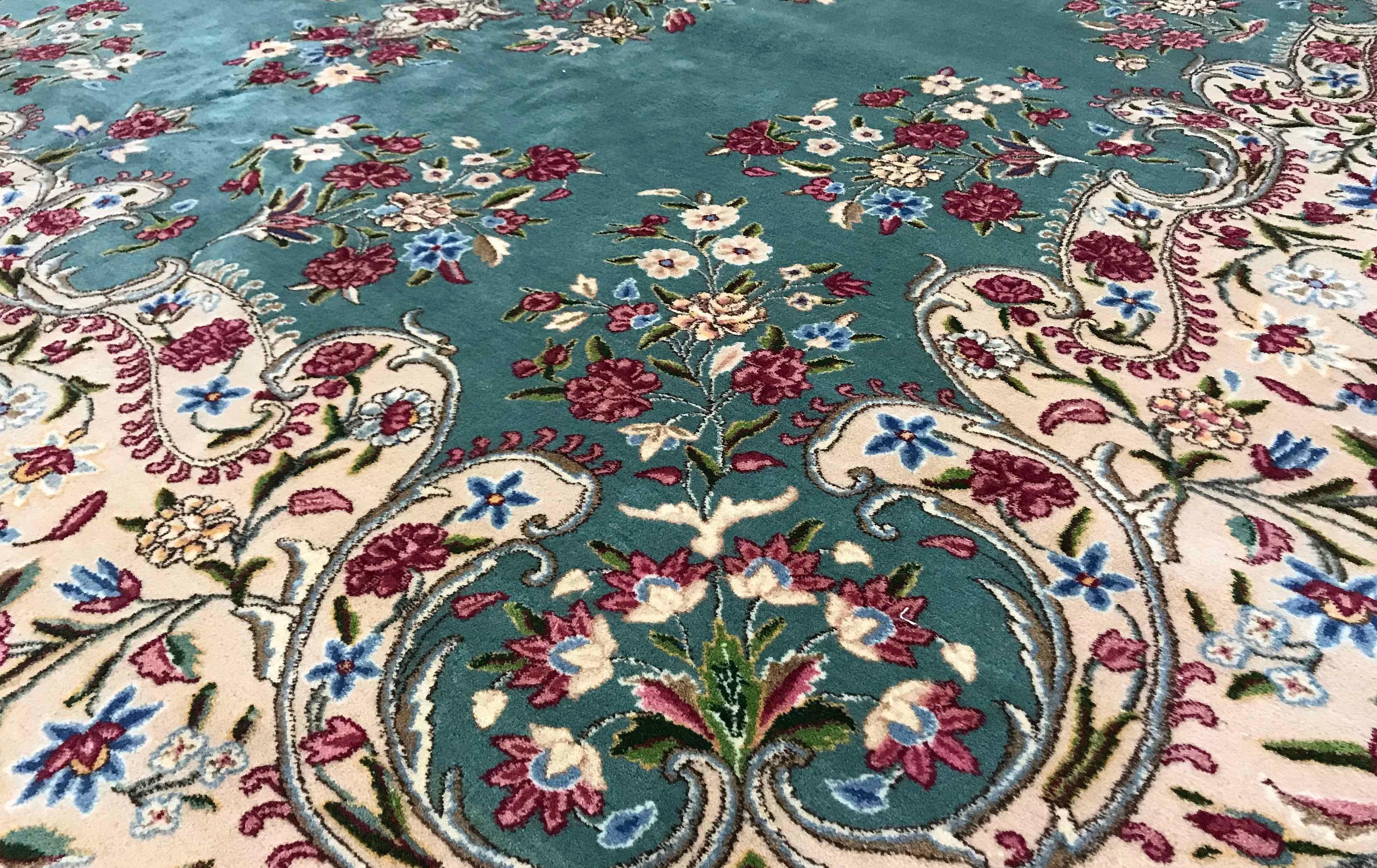 Vintage Persian Kerman rug, circa 1940. A wonderful composition to this rug with the soft green field both enclosing and surrounded by floral designs in soft gentle pastel colors to create this rug with a gentle style and look. Size: 9'10 x 13'5.