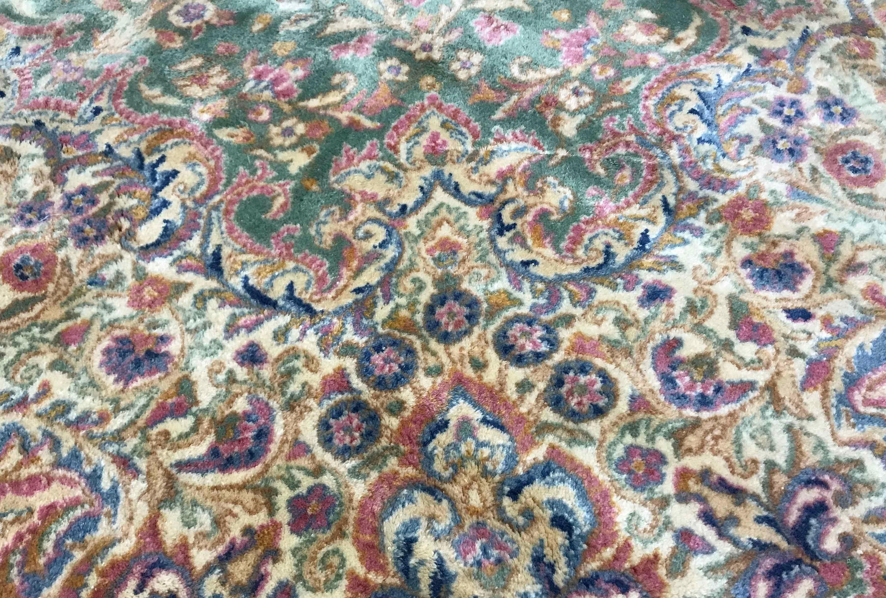 Vintage Persian Kerman Rug, circa 1940. A wonderful composition to this rug with the soft green field both enclosing and surrounded by floral designs in soft gentle pastel colors to create this rug with a gentle style and look. Size: 10' x 14'6.