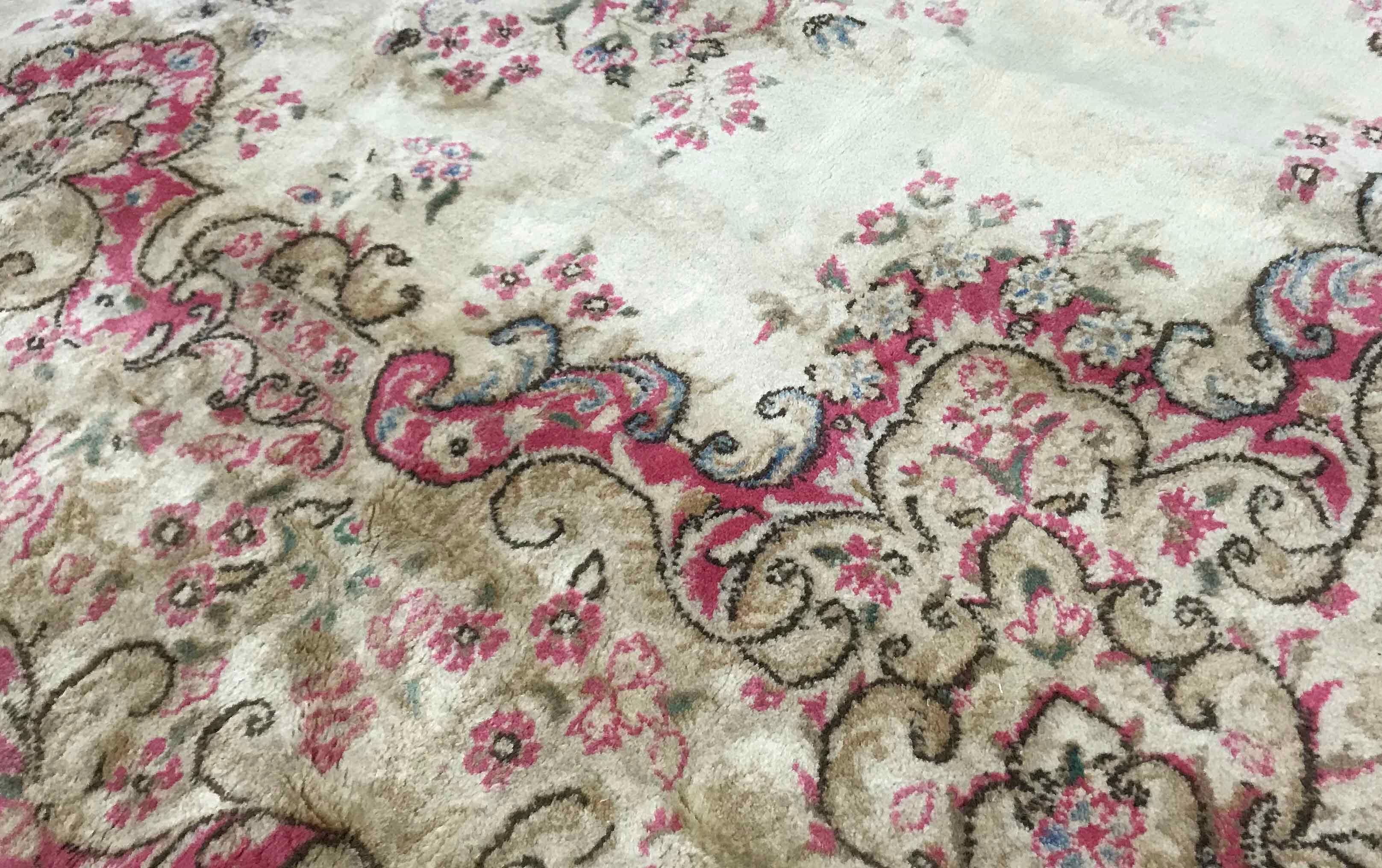 Vintage Persian Kerman rug, circa 1940. The ivory field containing soft floral designs all enclosed within a soft rose and green swirling border to complete this peaceful picture and wonderful looking rug. Size: 7'9 x 10'.