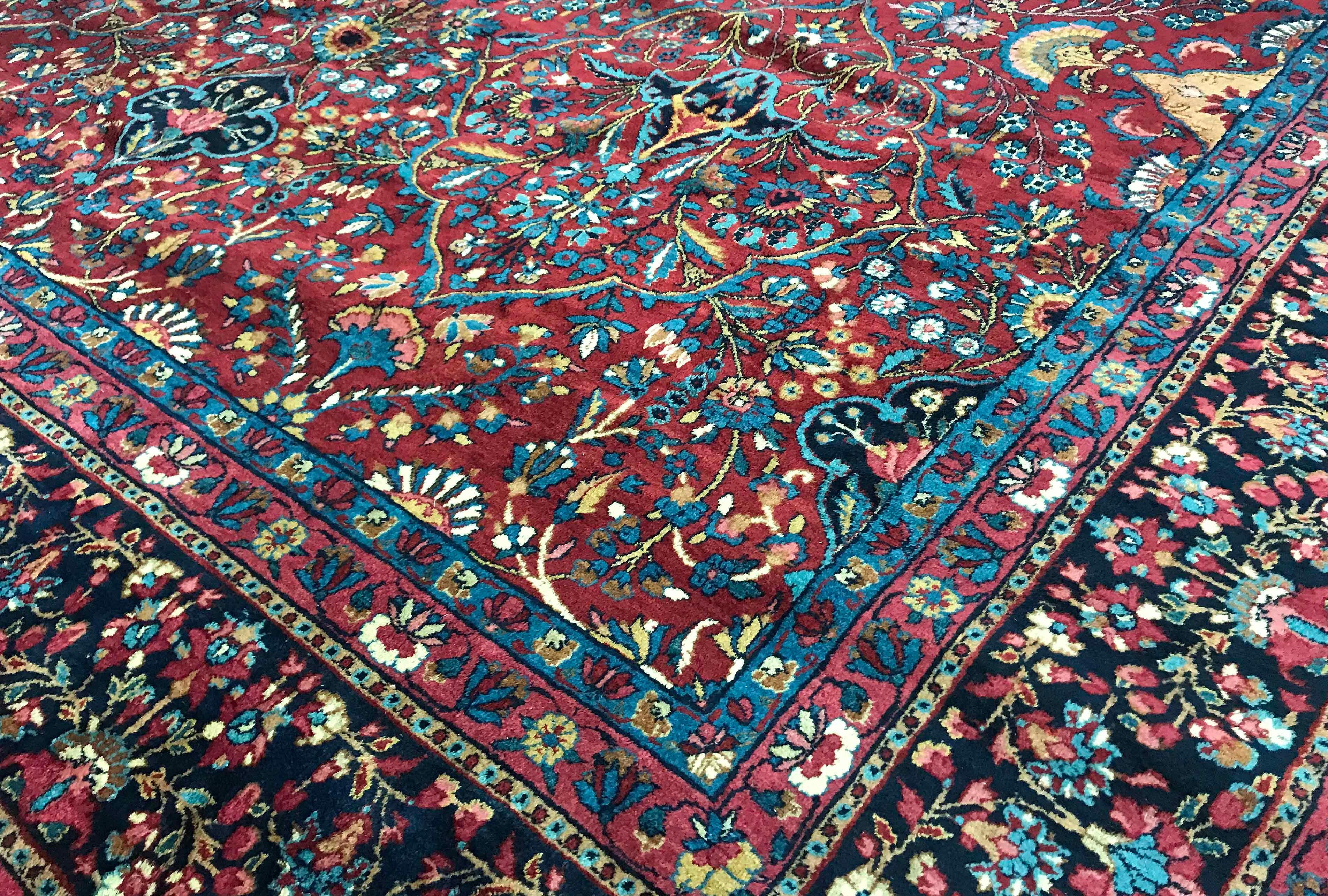 Vintage Persian Kerman rug, circa 1940. A vintage 1940s Kerman rug with an all-over design, the main red field with floral and vine designs encompassing the whole rug enclosed by an attractive navy border in the same style. Size:8'9 x 11'9.