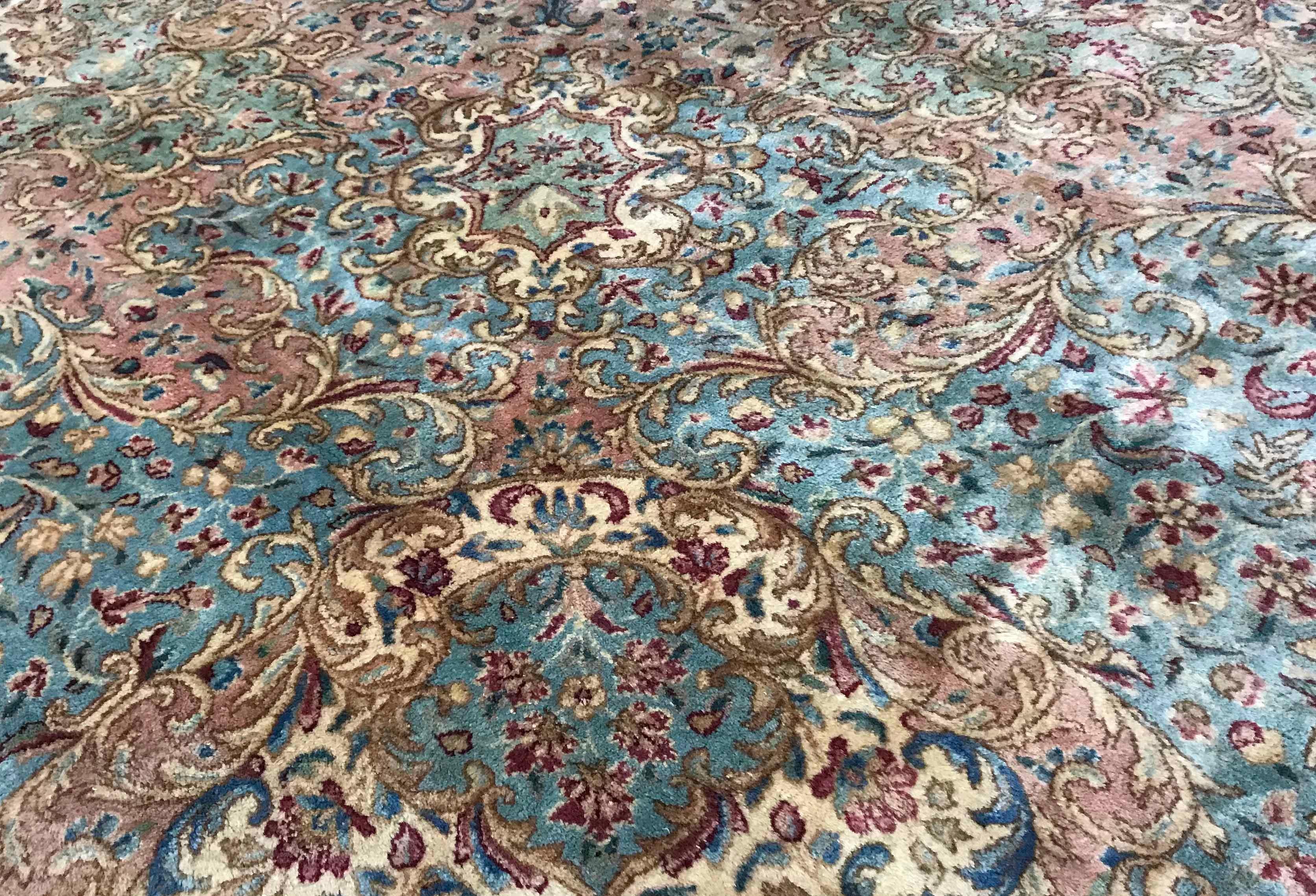 Vintage Persian Kerman, circa 1940. This large rug has a wonderfully soft central filed, filled with floral designs surrounding a central medallion in soft blues that extends into the border to create a relaxed and gentle feel to this 1940s vintage