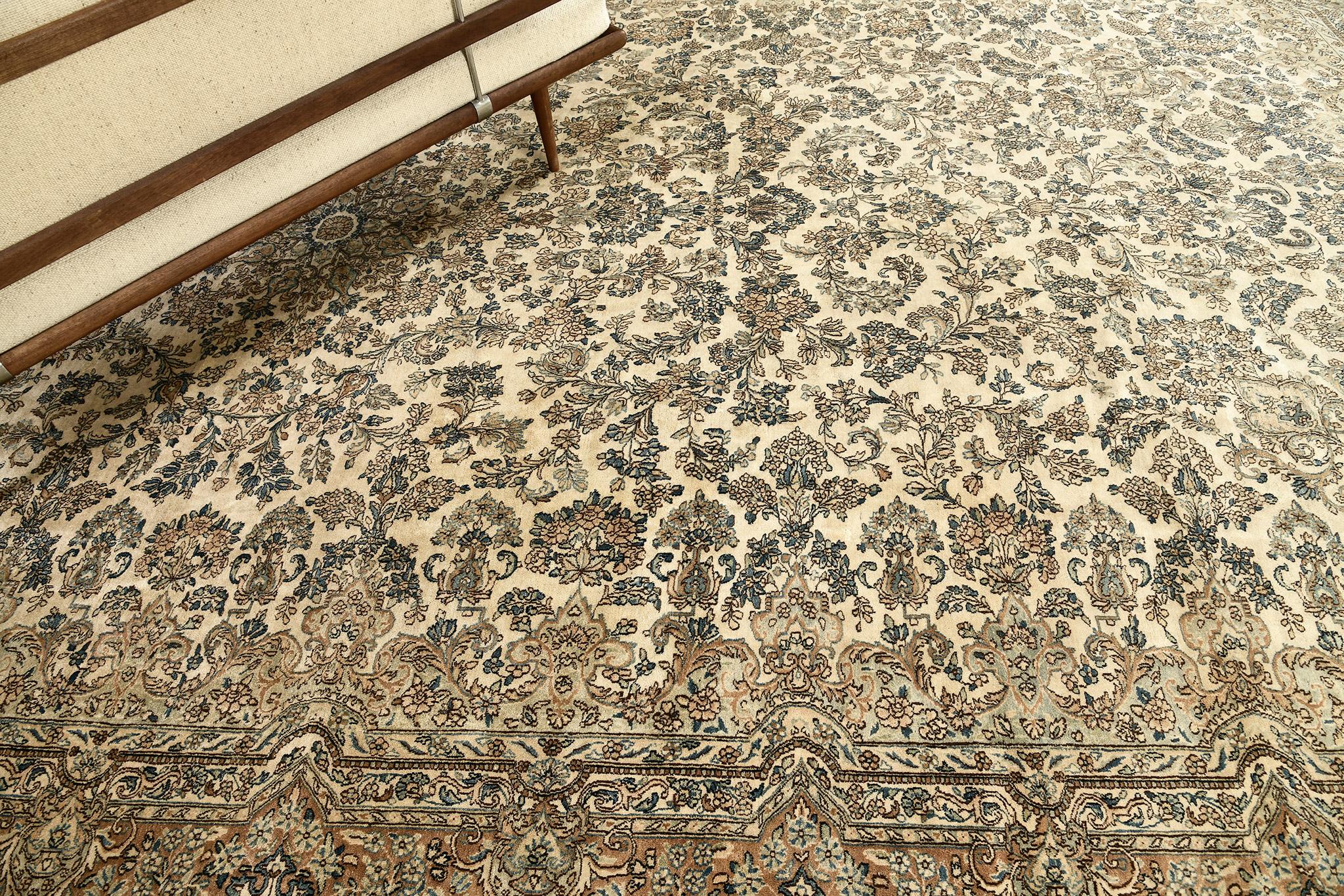 This exquisite and refined revival of Kerman rug reflects the intricacy and colors that can be seen in the field of allover leafy tendrils and glamorous florettes. This results in a wonderful balanced look and feel. A snake colored tone will make a